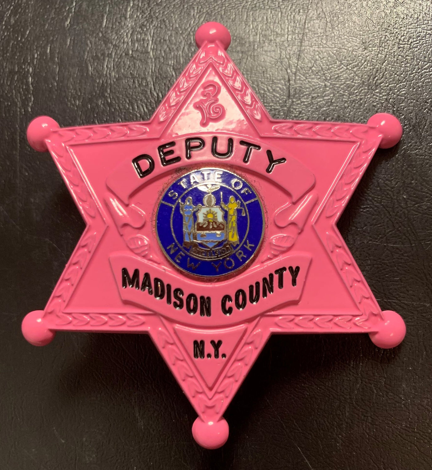 PINK BADGE — Pink badges worn this month by the Madison County Sheriff’s Office.