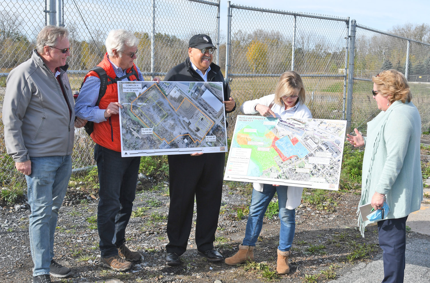 ALL THE POSSIBILITIES — Members of Counselors of Real Estate’s CRE Consulting Corps gather around the Rome Cable Complex 4 site off Henry Street to look at maps and share insights in redeveloping the brownfield Wednesday morning.  From left: Michael Hedden, managing director Integra Realty Resources, Philadelphia, Pa.; R.J. Neary, chairman of Investors Realty, Inc., Omaha, Neb.; Attorney Graham C. Grady, Taft Stettinius &amp; Hollister, LLP, Chicago, Ill.; Joelle Greenland, of the Center for Creative Land Recycling; and Christina Thoreson, lead counselor of Real Counsel, LLC, Lookout Mountain, Tenn.