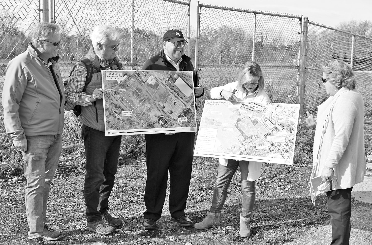 ALL THE POSSIBILITIES — Members of Counselors of Real Estate’s CRE Consulting Corps gather around the Rome Cable Complex 4 site off Henry Street to look at maps and share insights in redeveloping the brownfield Wednesday morning.  From left: Michael Hedden, managing director Integra Realty Resources, Philadelphia, Pa.; R.J. Neary, chairman of Investors Realty, Inc., Omaha, Neb.; Attorney Graham C. Grady, Taft Stettinius &amp; Hollister, LLP, Chicago, Ill.; Joelle Greenland, of the Center for Creative Land Recycling; and Christina Thoreson, lead counselor of Real Counsel, LLC, Lookout Mountain, Tenn.
