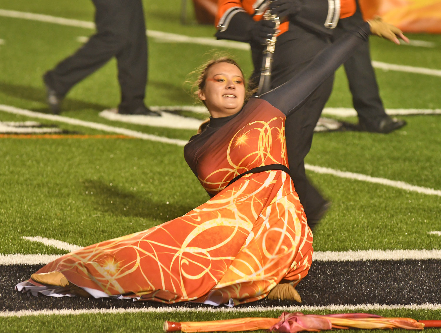 ON FIRE — The RFA Marching band delivered a striking performance on Wednesday night at RFA Stadium. Above, Colorguard member Karabrie Wiggins strikes a pose during the band’s performance of “Color of Fire.”