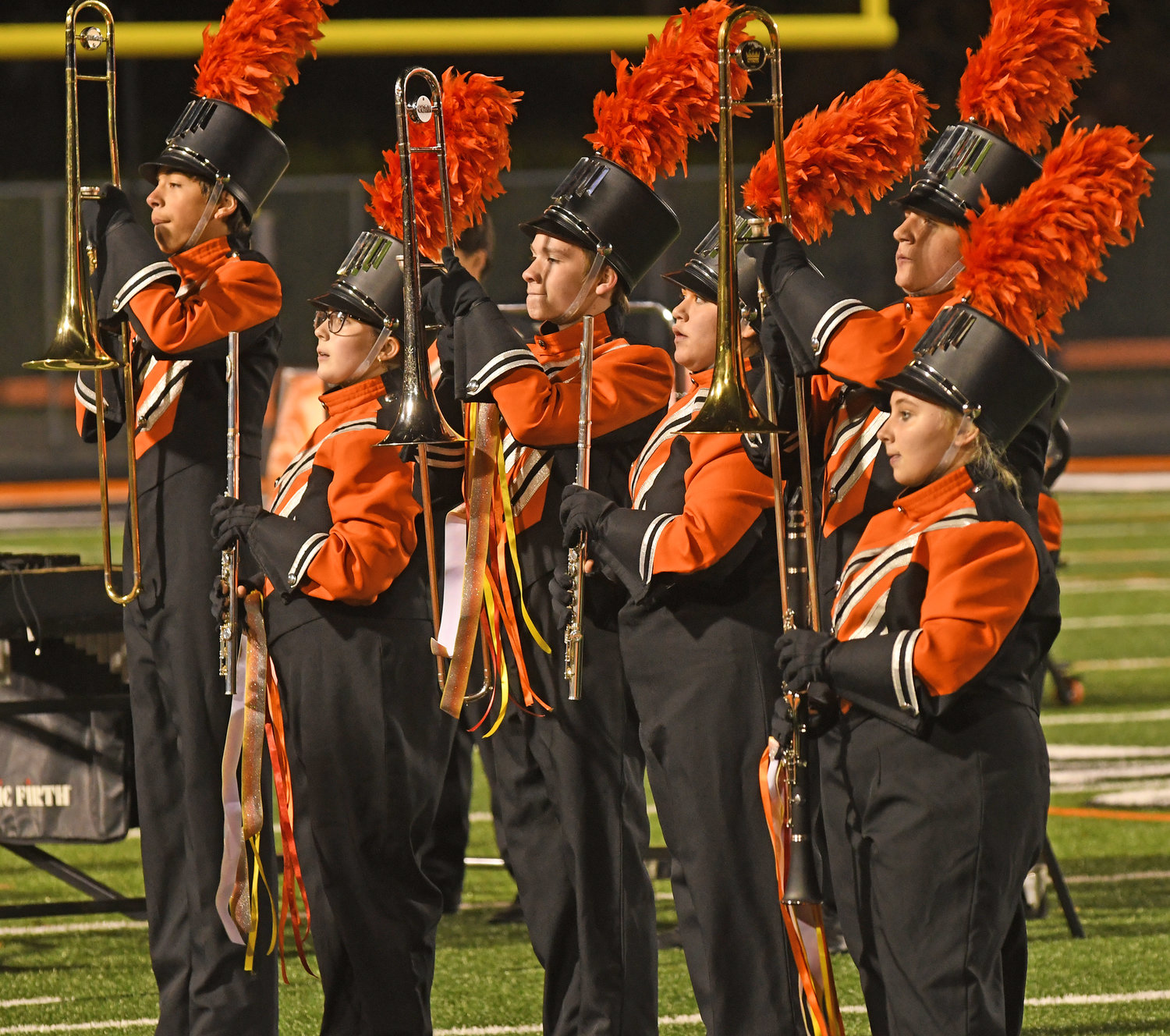 ON TO THE DOME — Rome Free Academy Marching Band members stand at attention at the end of their performance of "Colors of Fire" at Wednesday's Community Show at RFA Stadium. The band will perform the show during competition in the Large School Division 2 field at the  New York State Field Band State Championships on Sunday at the Carrier Dome.