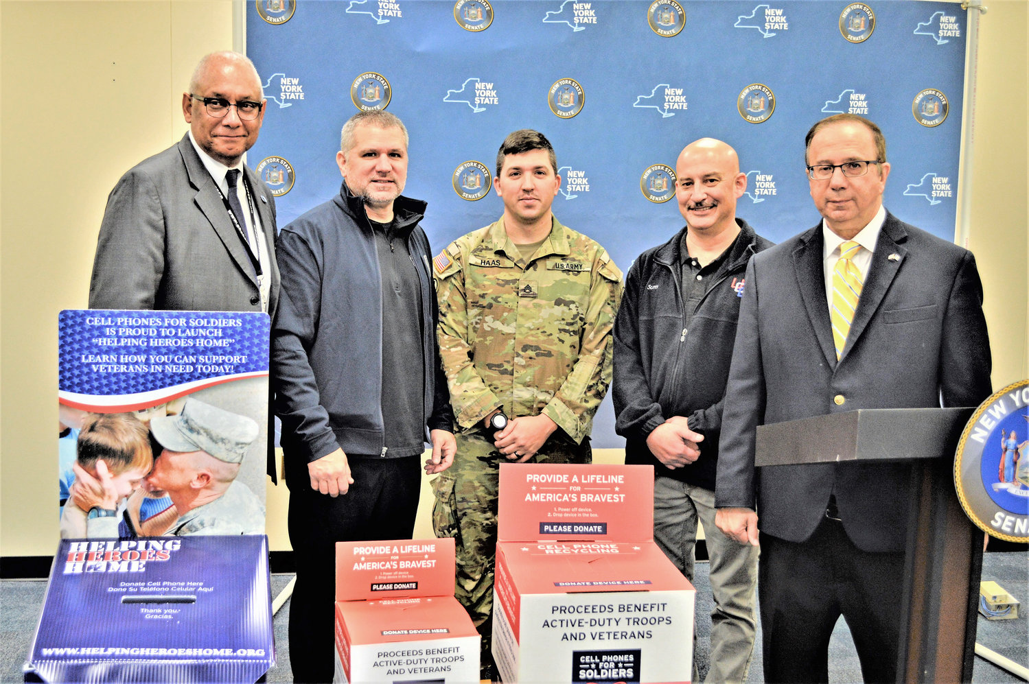 New York State Sen. Joseph Griffo, R-I-C-Rome, was joined by AT&amp;T, Army National Guard SSG. Charles Haas, the Central New York Veterans Outreach Center and the Utica Comets to kick off this year's Cell Phones For Soldiers collection drive. Beginning Thursday, Nov. 11 and going until Saturday, Dec. 11, residents of the 47th Senate District can drop off unused or unwanted cell phones at several locations. For every donated phone, mobile device or tablet valued at $5, Cell Phones For Soldiers provides 2.5 hours of free talk time to deployed troops via calling cards. Pictured, from left to right: Greeley Ford with AT&amp;T, Rick Redmond, senior vice president of facility operations at the Adirondack Bank Center, SSG. Haas, Scott Zoeckler with the Central New York Veterans Outreach Center and Sen. Griffo.