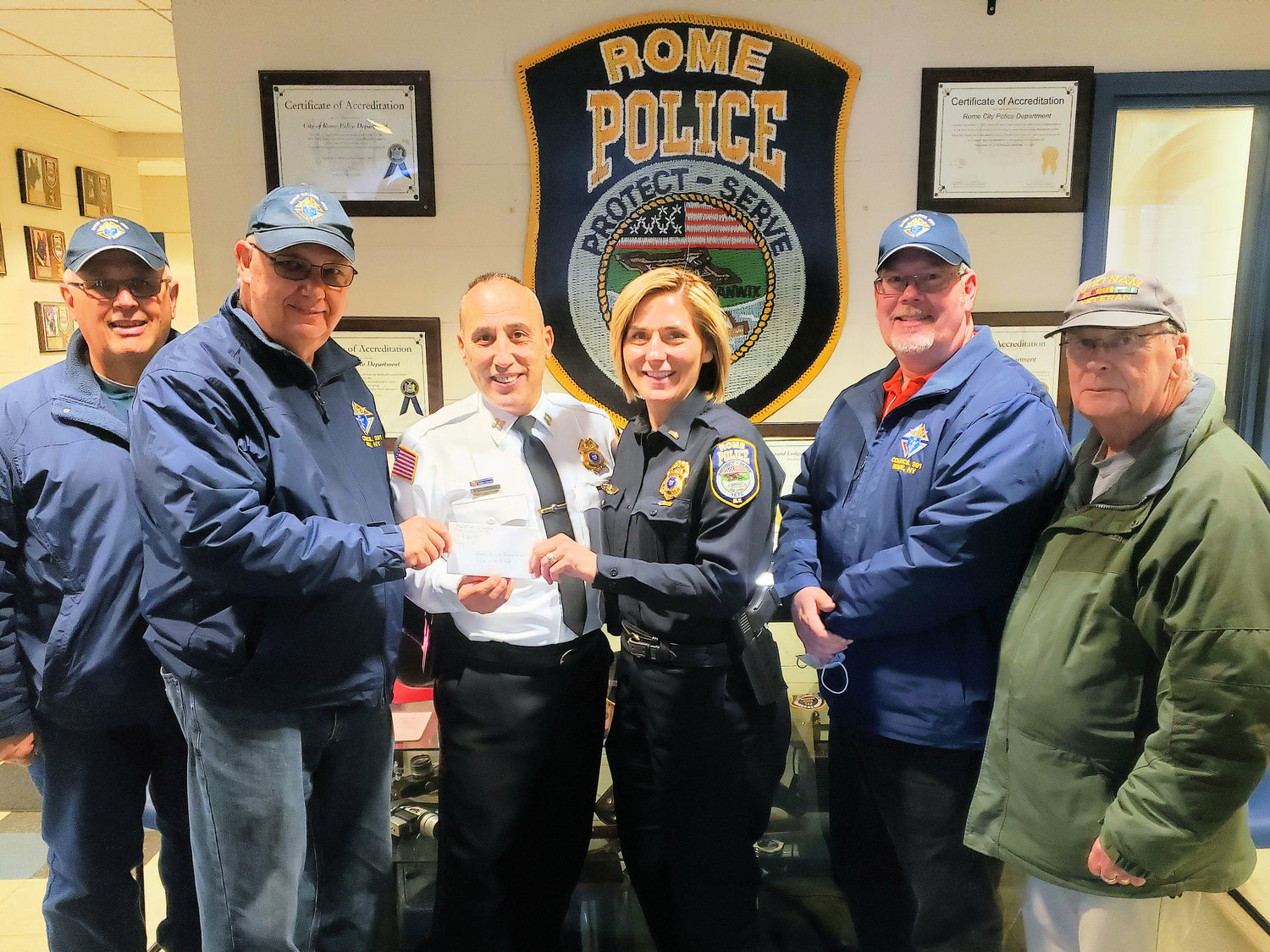 READY TO SHOP — The Rome Council #391 of the Knights of Columbus has begun its 2021 Season of Charitable Giving, presenting a $1,000 check to the Rome Police Benevolent Fund’s “Shop With a Cop” program.  From left: Joseph Carolla, Knights of Columbus trustee; David Zasada, KOC grand knight; Police Capt. Thomas Corigliano; Lt. Sharon Rood; Kevin Piatt, deputy grand knight; and M. Tedd Kehoe, KOC financial secretary. The annual Shop with a Cop event will be held in December, police officials said. To learn more about the Knights, see their website at kofc.org.