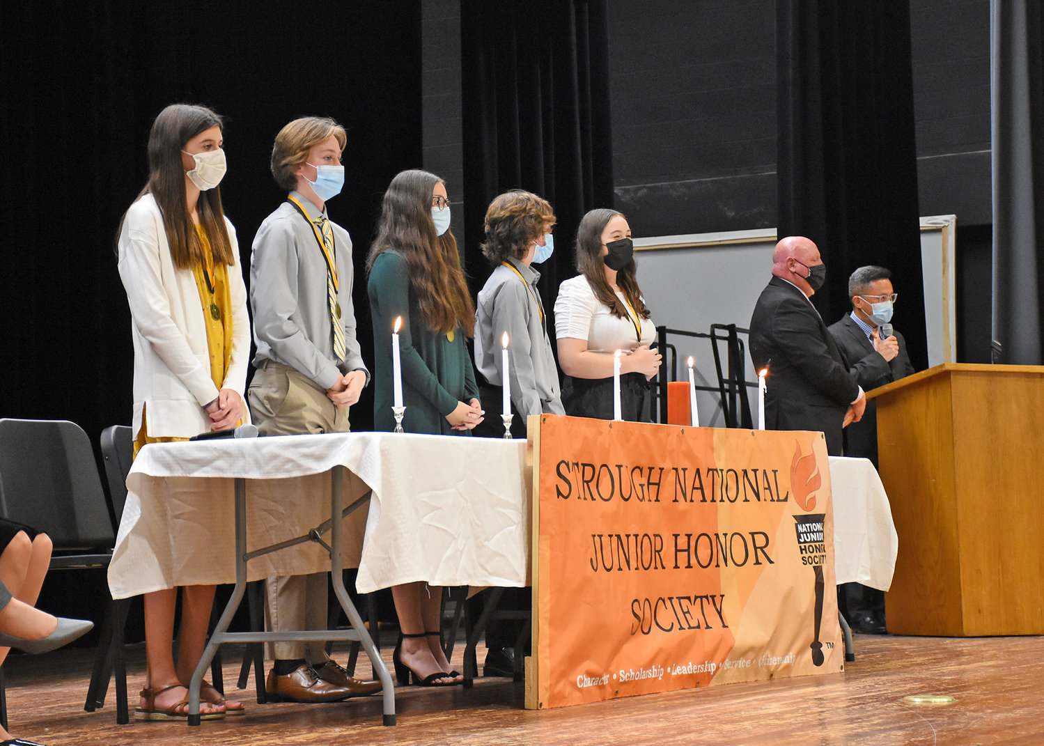 LIGHTING THE CANDLES — Five students participated in a candle-lighting ceremony during the National Junior Honor Society induction ceremony at Strough Middle School, with candles symbolizing five categories. Among them: Scholarship, Hannah Clark; Service, Jacob Bruno; Character, Kadence Barton; Leadership, Jaemeson Keith; Citizenship, Madeline Feeney.