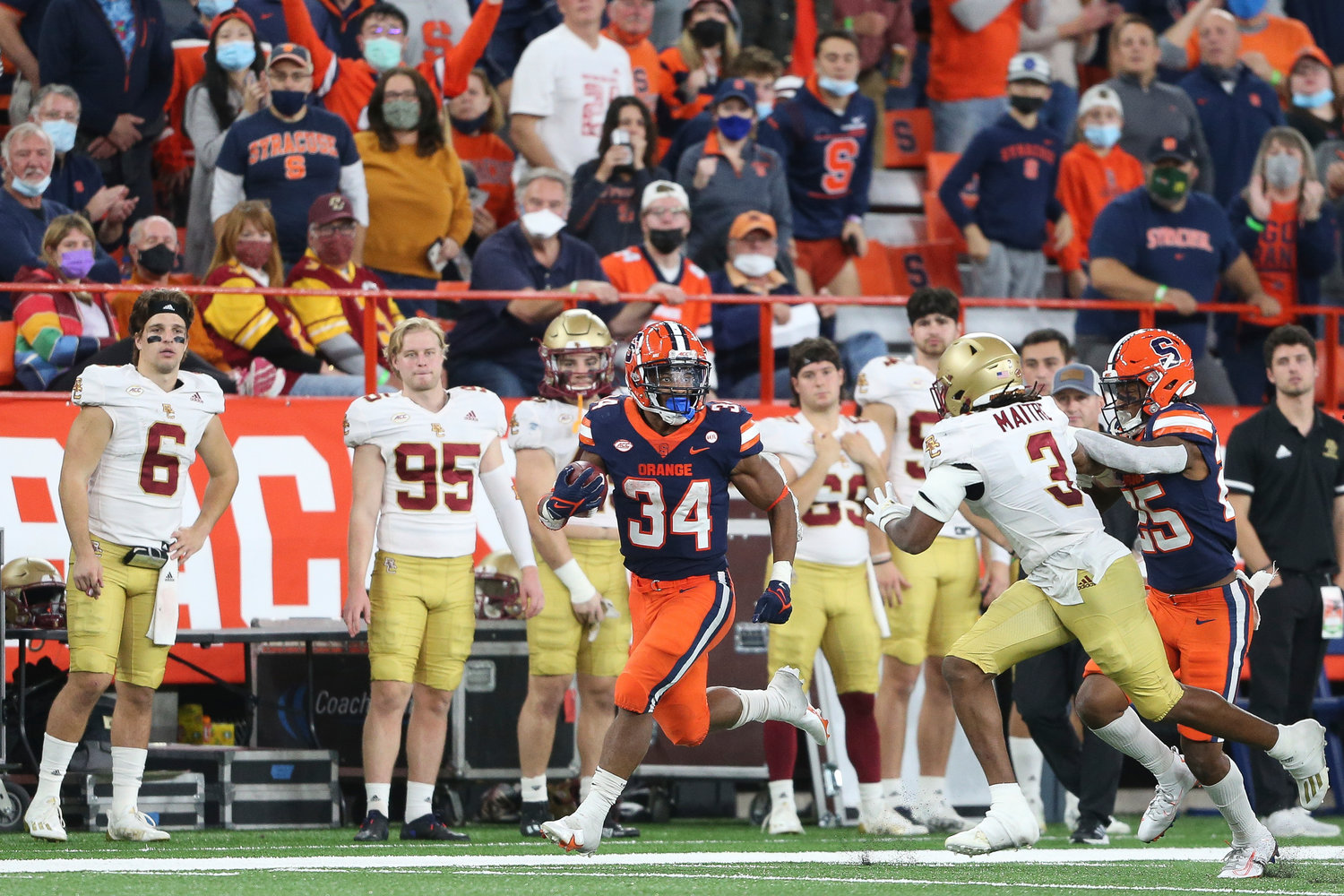 DOWN THE SIDELINE — Syracuse running back Sean Tucker (34) is chased by Boston College defensive back Jason Maitre (3) while running during the second half of an NCAA football game in Syracuse, N.Y., Saturday, Oct. 30. Tucker believes he’ll be back in Central New York next season.