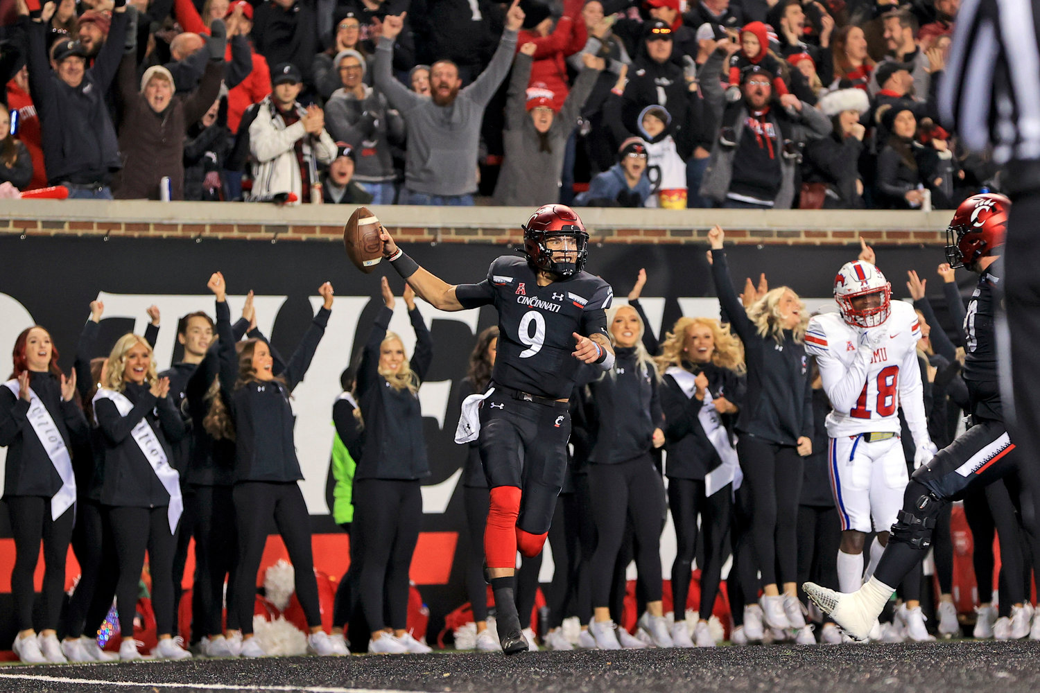 INTO CFP TOP 4 — Cincinnati quarterback Desmond Ridder celebrates after catching a touchdown pass during the second half of an NCAA college football game against SMU, Saturday, Nov. 20, 2021, in Cincinnati. Cincinnati won 48-14. The Bearcats are ranked No. 4 in this week’s College Football Playoff rankings.