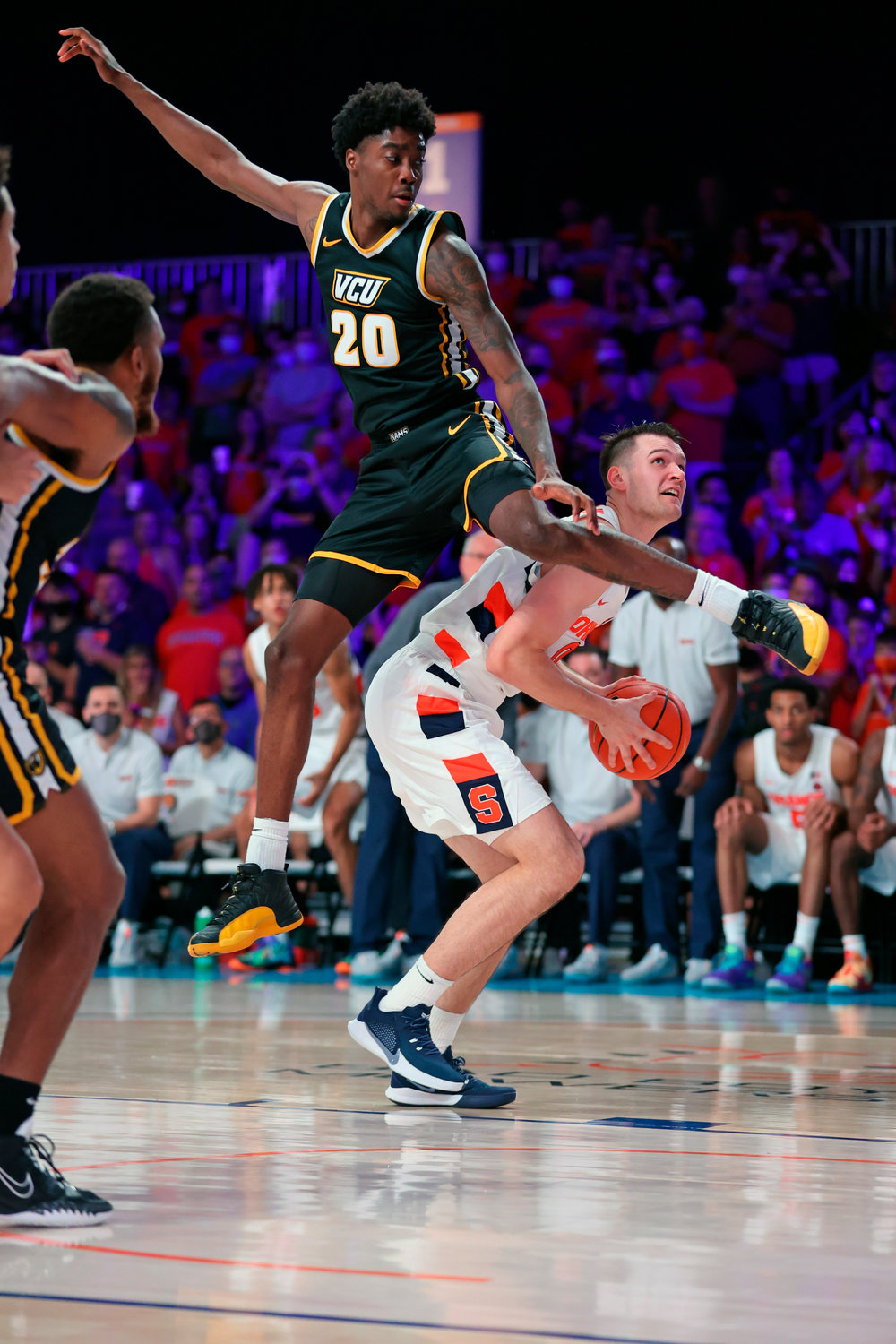 LOOKING FOR A SHOT — In a photo provided by Bahamas Visual Services, Syracuse forward Jimmy Boeheim (0) goes up for the shot as Virginia Commonwealth forward Hason Ward (20) defends during an NCAA college basketball game at Paradise Island, Bahamas, Wednesday, Nov. 24. VCU defeated Syracuse, 67-55.