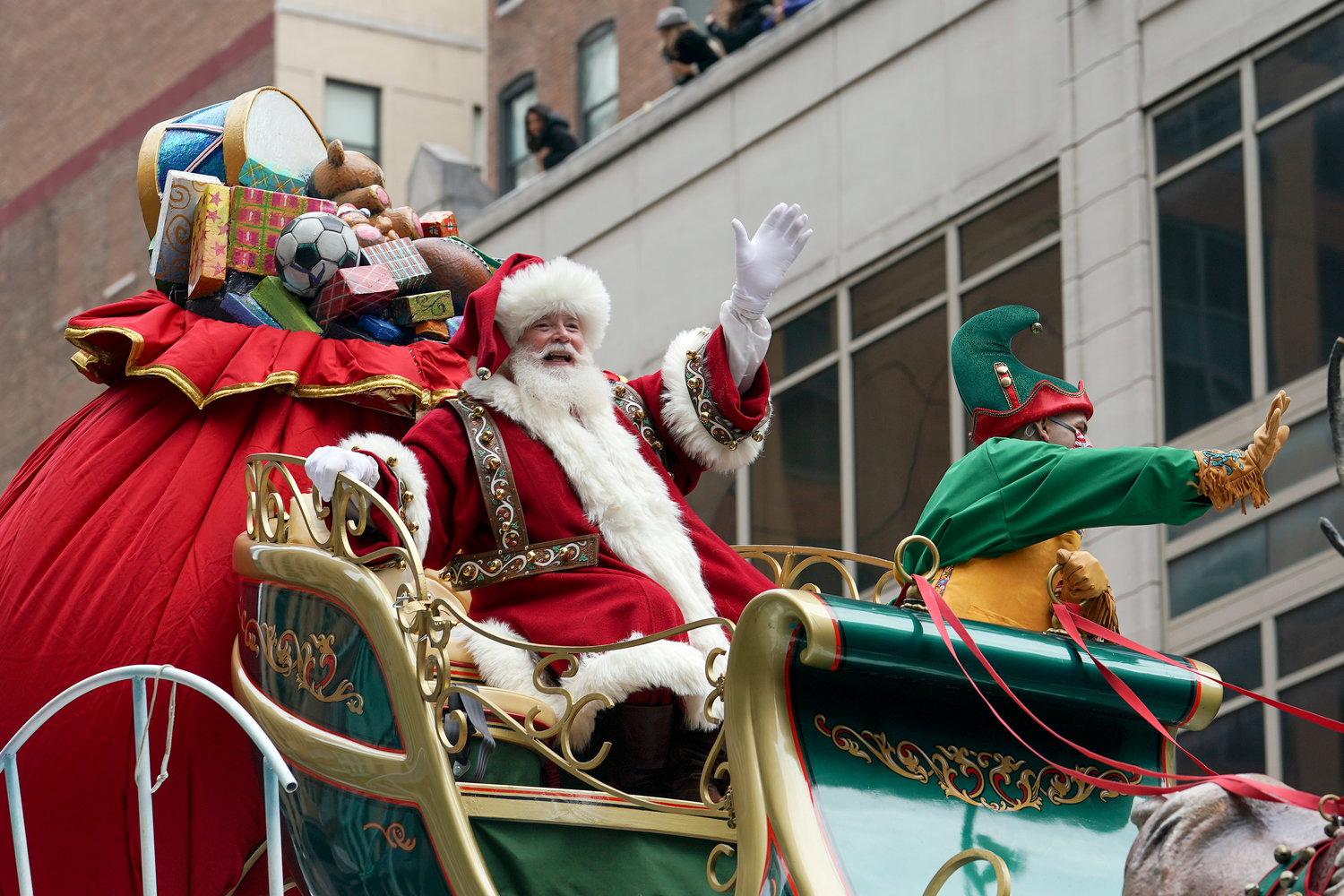 GUEST OF HONOR — Santa Claus waves from atop a float while riding along 6th Ave. during the Macy’s Thanksgiving Day Parade Thursday in New York.