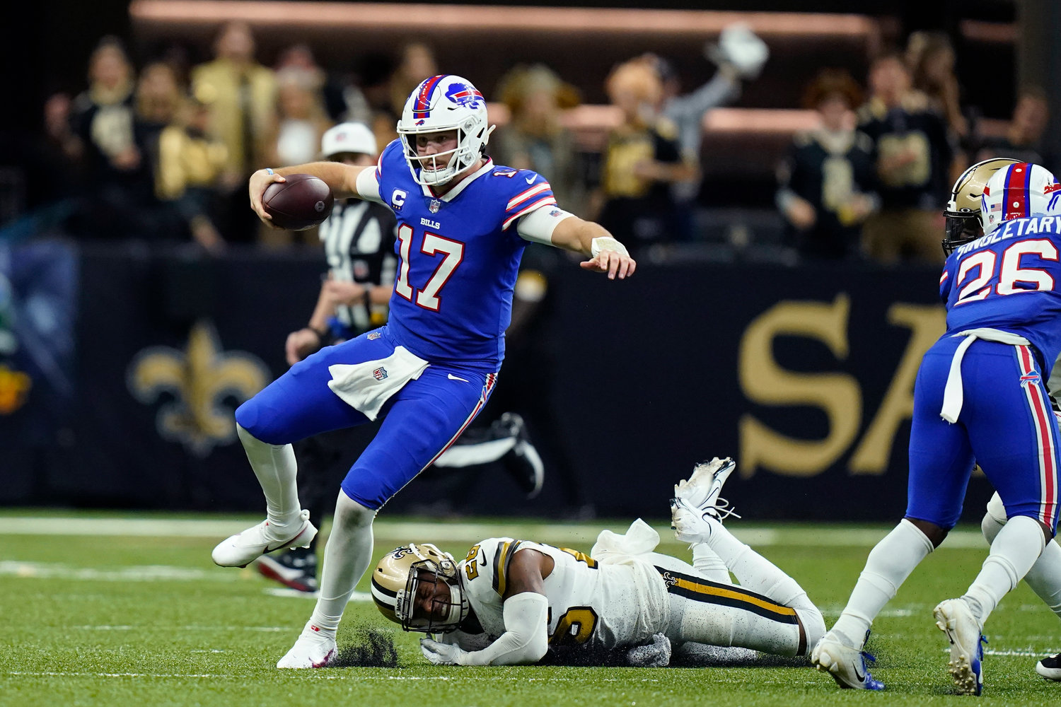 BREAKING THE TACKLE — Buffalo Bills quarterback Josh Allen (17) carries against New Orleans Saints cornerback P.J. Williams in the second half of an NFL game in New Orleans, Thursday, Nov. 25. The Bills won, 31-6.
