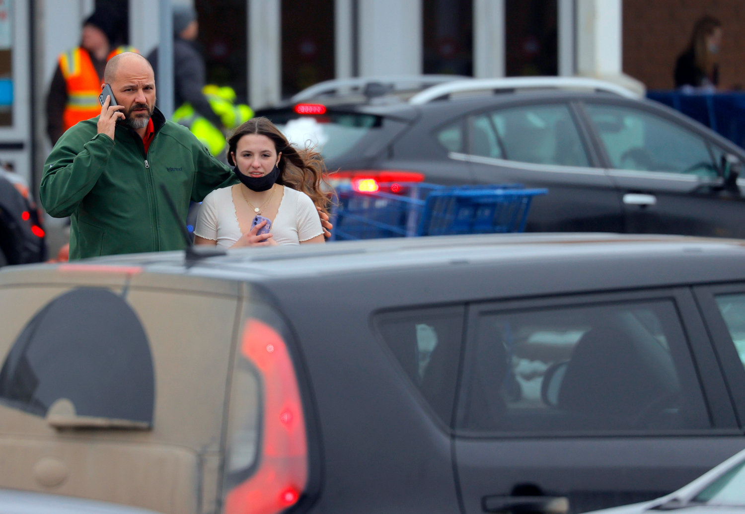 SAFE — A father escorts his daughter after a shooting Tuesday at Oxford High School in Oxford, Mich., north of Detroit.