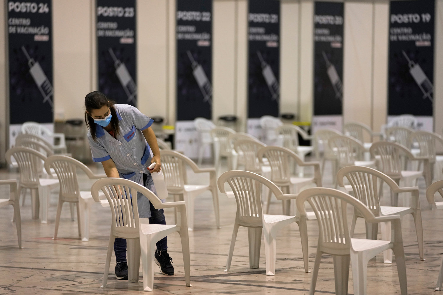 VACCINATION CENTER — A worker arranges chairs at a new vaccination center in Lisbon, Portugal, on Tuesday. Portuguese health authorities on Monday identified 13 cases of the omicron coronavirus variant among members of a top soccer club and were investigating whether it was one of the first reported cases of local transmission of the virus outside of southern Africa.