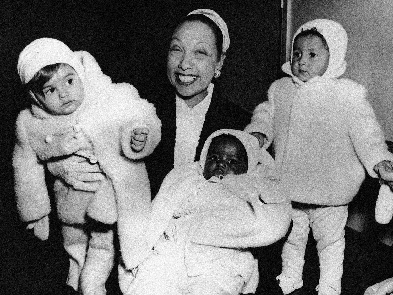 FILE- Actress Josephine Baker in her apartment at the Hotel Forresta near Stockholm, Sweden on Dec. 7, 1957, with three of her adopted children, Marianne, left, Koffi, center, and Brahim. France is inducting Josephine Baker ‚Äì Missouri-born cabaret dancer, French Resistance fighter and civil rights leader ‚Äì into its Pantheon, the first Black woman honored in the final resting place of France's most revered luminaries. (AP Photo, File)