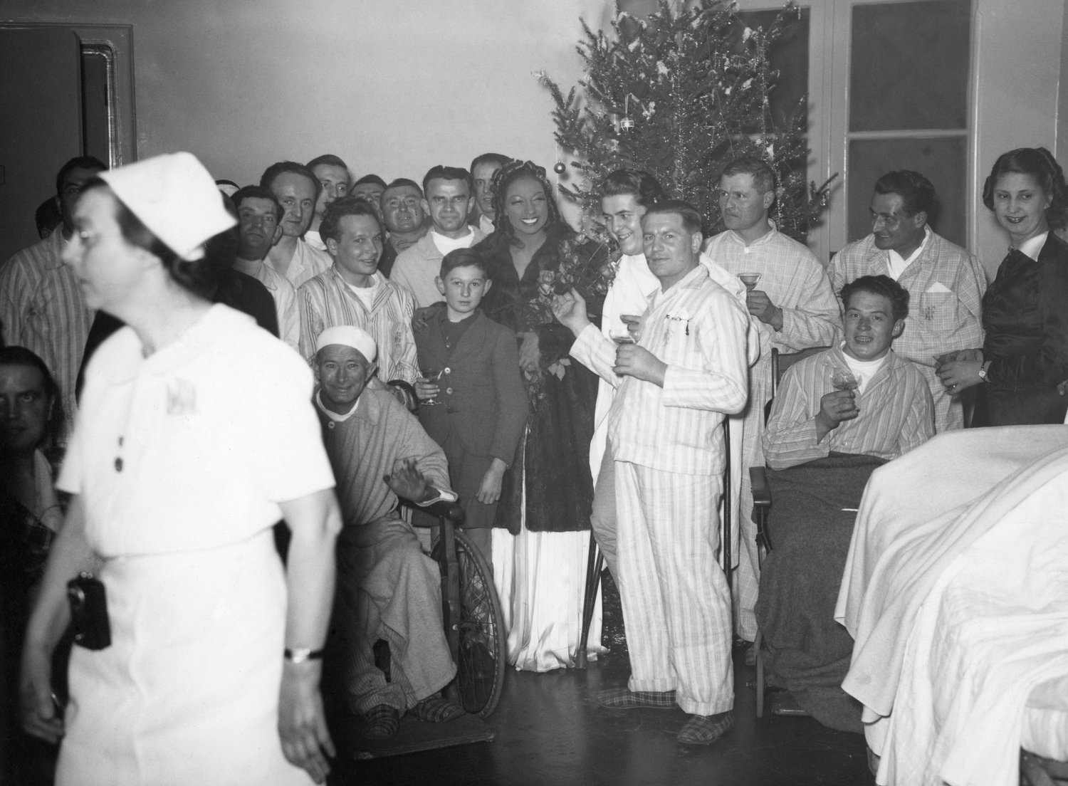 FILE - Josephine Baker with patients at a American hospital in Paris, France, where she sang for French soldiers on Christmas Day, Dec. 25, 1939. France is inducting Josephine Baker ‚Äì Missouri-born cabaret dancer, French Resistance fighter and civil rights leader ‚Äì into its Pantheon, the first Black woman honored in the final resting place of France's most revered luminaries. (AP Photo, File)