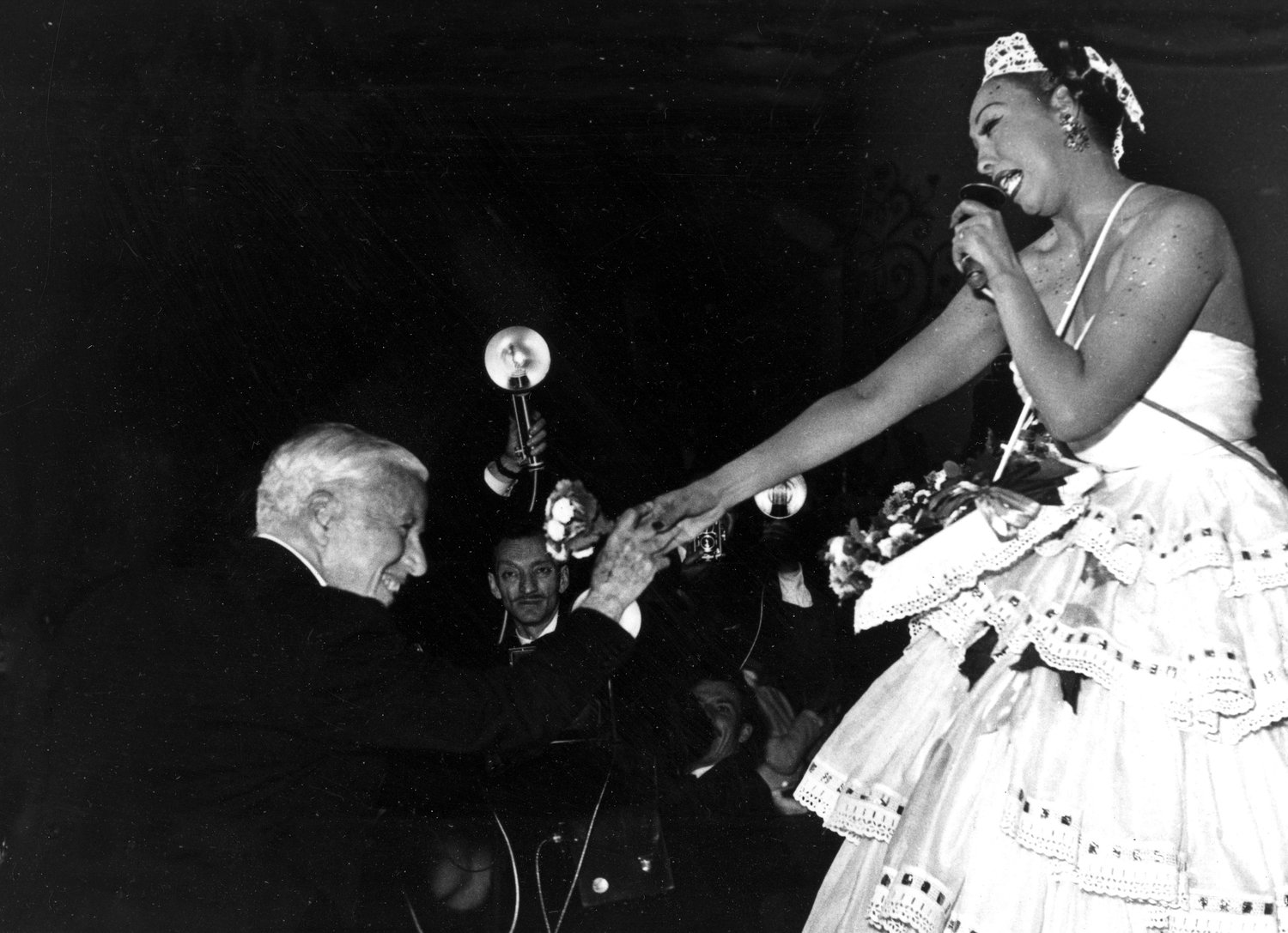 FILE - Charlie Chaplin congratulates entertainer Josephine Baker after her performance at the charity gala "Le Bal des Petits Lits Blancs," at the Moulin Rouge in Paris, on May 20, 1953. France is inducting Josephine Baker ‚Äì Missouri-born cabaret dancer, French Resistance fighter and civil rights leader ‚Äì into its Pantheon, the first Black woman honored in the final resting place of France's most revered luminaries. (AP Photo, File)
