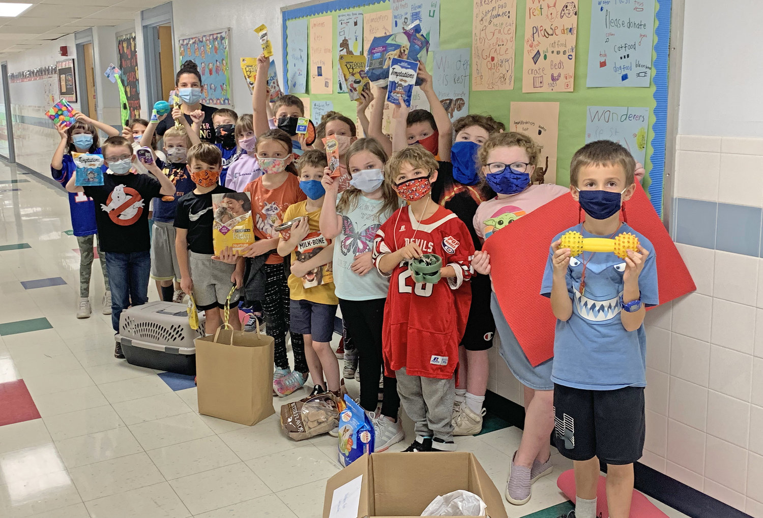 STUDENTS DONATE — E.A. McAllister students in Danielle Jeffery’s class pose with the items they collected and donated to Wanderers’ Rest.