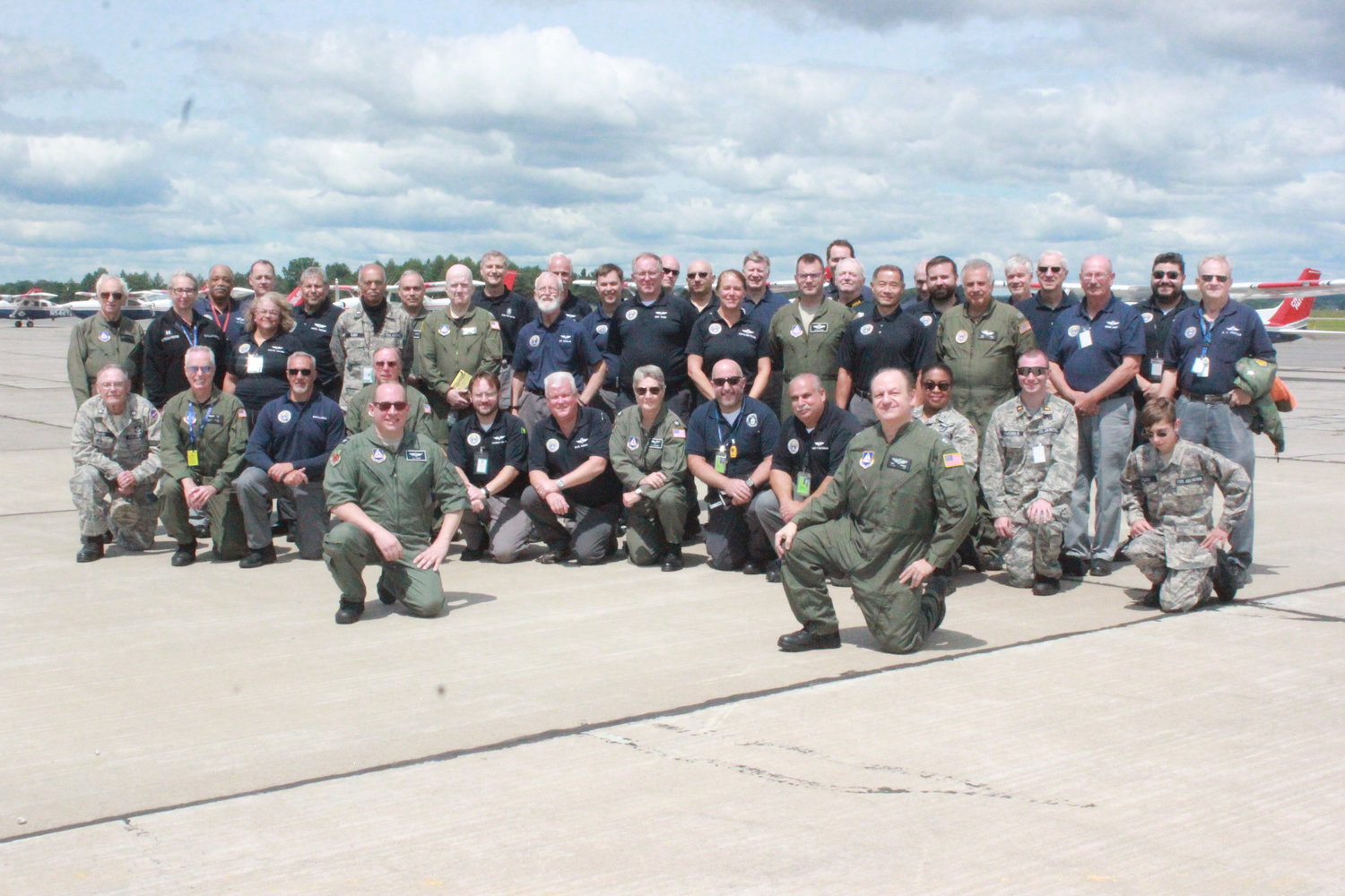 REPORTING IN — Aircraft and crew gather for a group photo prior to a large-scale disaster relief training exercise held in August at the Griffiss International Airport earlier this year.