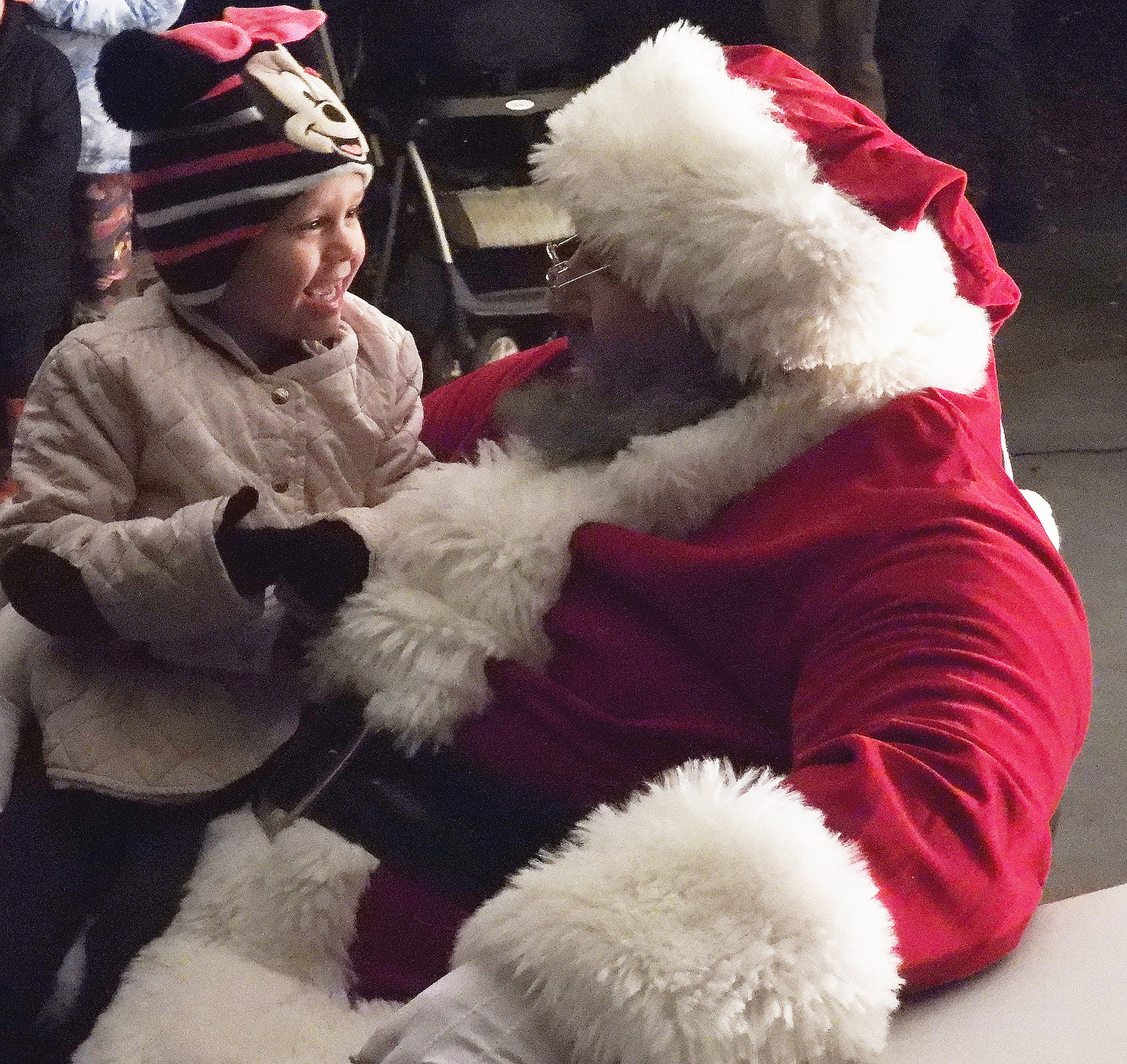 CHRISTMAS MAGIC — A little girl laughs excitedly as she comes face to face with Santa Claus at Higinbotham Park on Friday, Dec. 3 during the city of Oneida's annual tree lighting ceremony. For more photos of the Oneida Christmas Festival, visit the Rome Sentinel website.