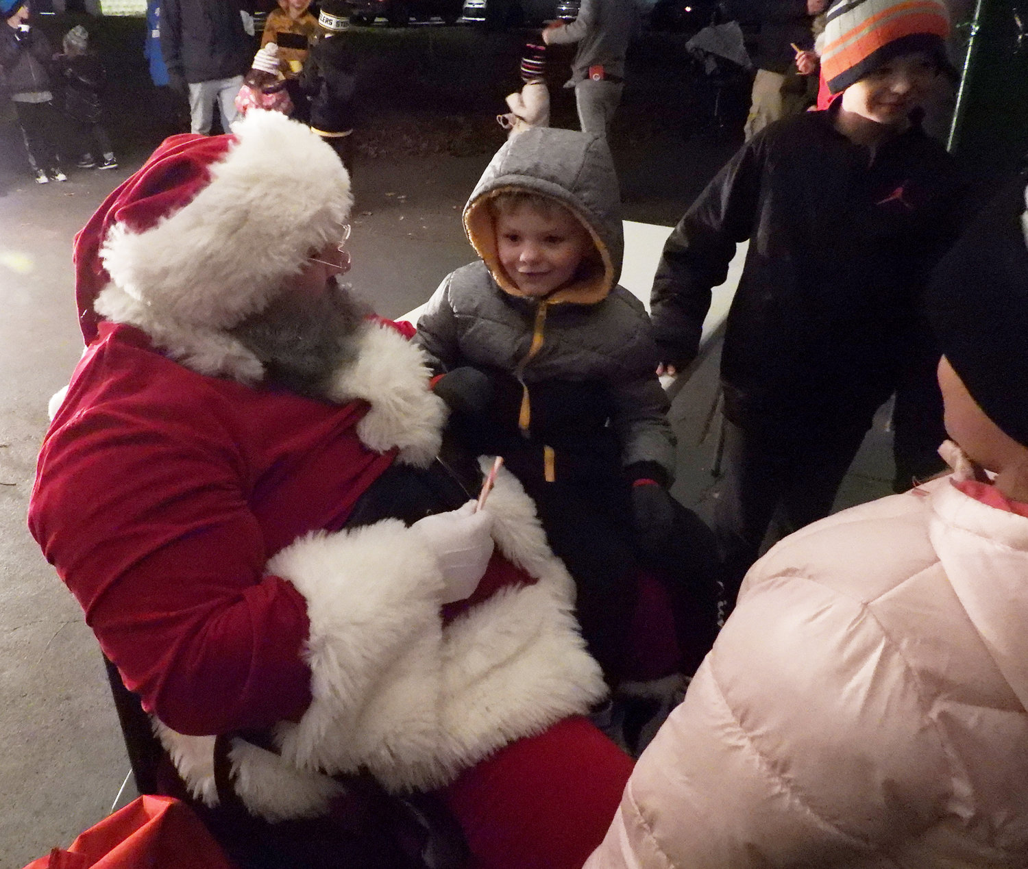JOLLY OLD SAINT NICHOLAS — A little boy thinks about what he wants for Christmas as he sits on Santa's lap at Higinbotham Park on Friday, Dec. 3 during the city of Oneida's annual tree lighting ceremony. For more photos of the Oneida Christmas Festival, visit the Rome Sentinel website.
