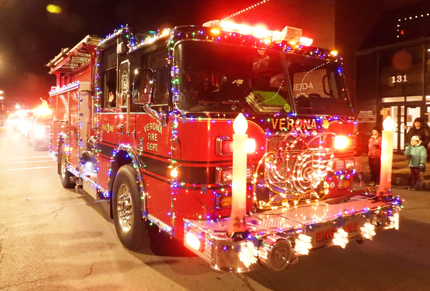 FESTIVE FIREFIGHTERS — The Verona Fire Department's Engine 3 is dressed to the nines for the holiday season and blares its siren for everyone on Main Street for the first-ever Oneida Parade of Lights. For more photos of the Oneida Christmas Festival, visit the Rome Sentinel website.