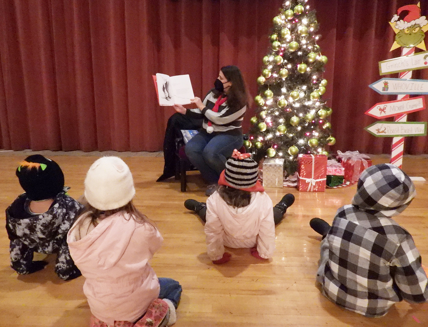 STORY TIME AT THE KALLET — Youth Coordinator Megan Gillander of the Oneida Public Library reads Dr. Seuss's "How the Grinch Stole Christmas" and other holiday stories at the Kallet Civic Center. For more photos of the Oneida Christmas Festival, visit the Rome Sentinel website.