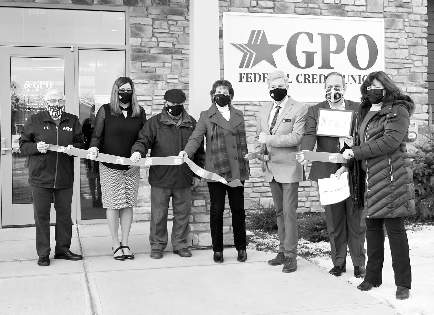OPEN FOR BUSINESS — Officials with GPO Federal Credit Union, members of the Rome Area Chamber of Commerce and local dignitaries gather on Monday for a ribbon-cutting ceremony to formally open the new GPO branch at 1701 N. James St. Following the ribbon cutting ceremony, Greater Rome Utica Chapter Military Offices Association of America (GRUC-MOAA) and Rome Food Pantry joined officials for a ceremonial check presentation. The new full-service branch with a drive-thru ATM offers an array of loan and deposit products, while the conference room will host the credit union’s free Financial Education workshops and Financial Counseling sessions.