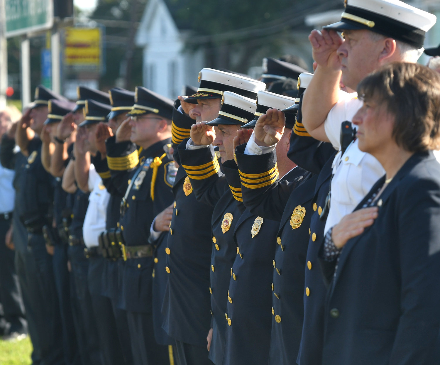 SALUTE — Members of the Rome Fire Department and Rome Police Department, along with Mayor Jacqueline M. Izzo, salute during the national anthem at the 9/11 remembrance ceremony in Rome.