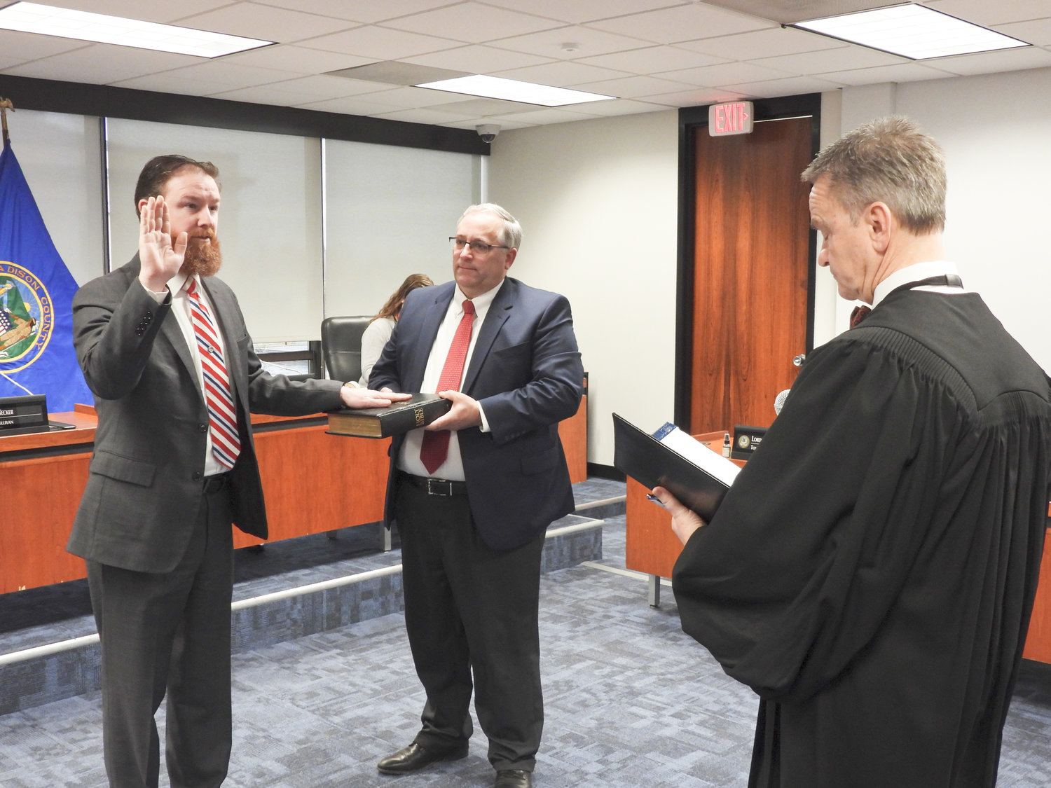 ANOTHER TERM — Michael Keville, left, is sworn in as Madison County clerk by Judge Patrick O’Sullivan, who was recently elected as a justice of the supreme court for the 6th Judicial District. Madison County Chairman John Becker holds the Bible.