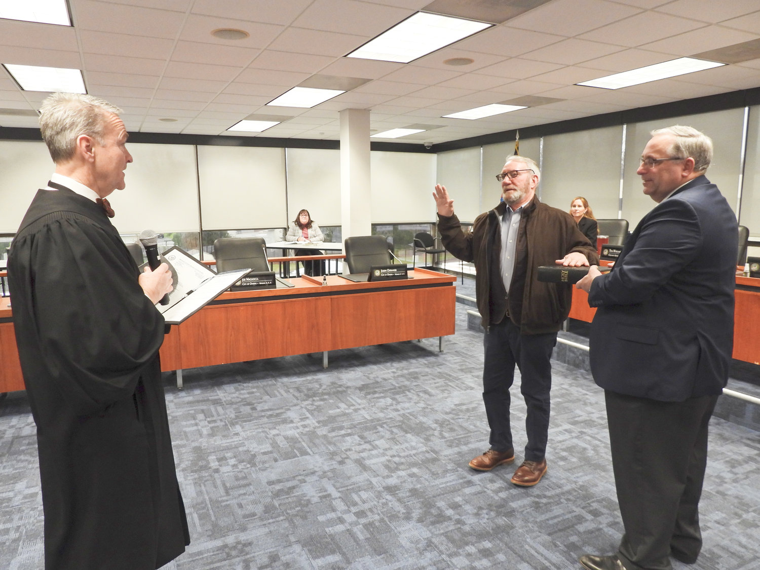LINCOLN COUNCILOR — Doug Fusilo, center, is sworn in as one of the Lincoln councilors. Fusilo is sworn in by Judge Patrick O'Sullivan, who was recently elected as a justice of the supreme court for the 6th Judicial District. Madison County Chairman John Becker holds the Bible.