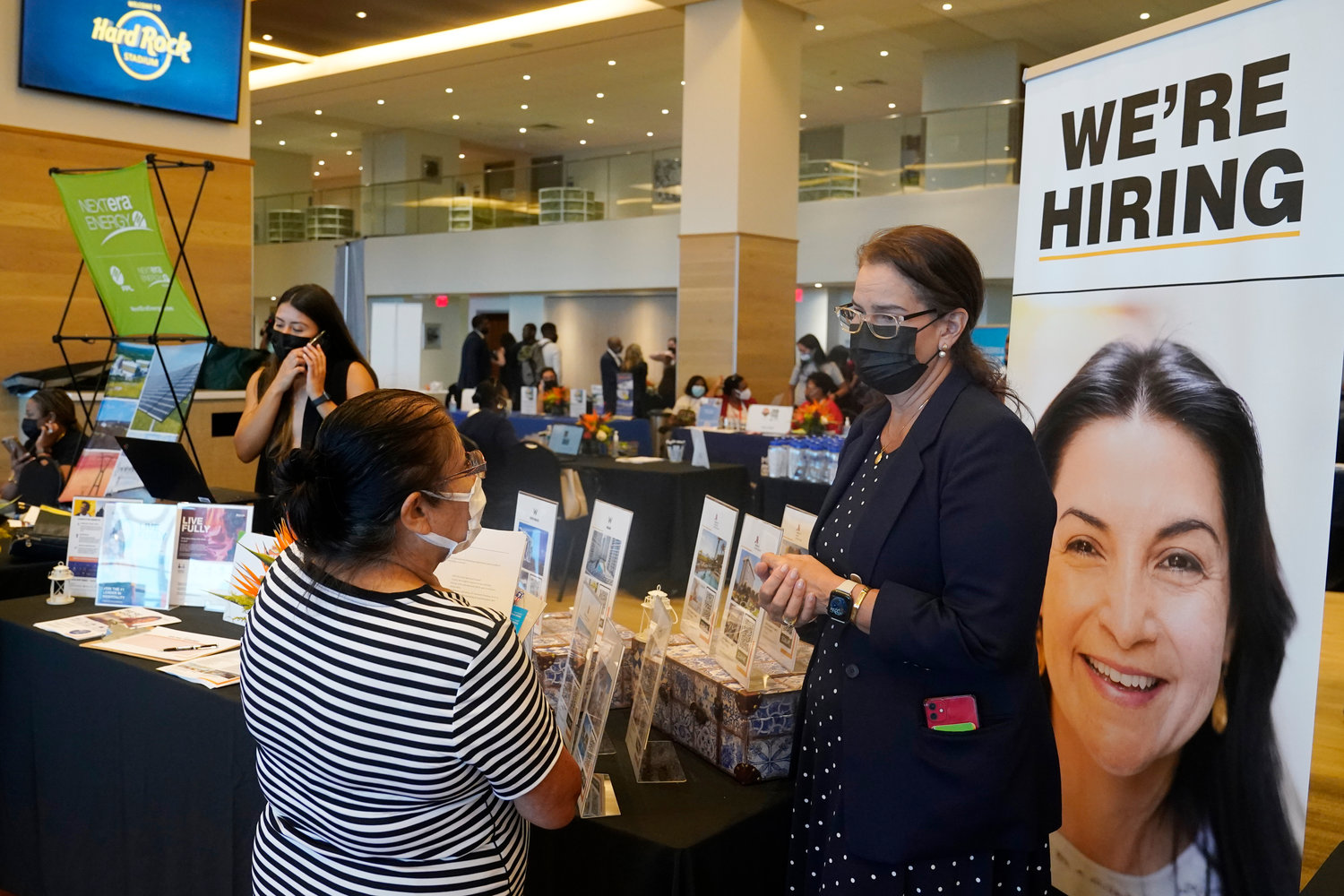 FILE - Marriott human resources recruiter Mariela Cuevas, left, talks to Lisbet Oliveros, during a job fair at Hard Rock Stadium, Friday, Sept. 3, 2021, in Miami Gardens, Fla.  The number of Americans applying for unemployment benefits fell to a new pandemic low 267,000 last week, another sign that the job market is recovering from last year’s sharp coronavirus downturn. Jobless claims fell by 4,000 last week, the Labor Department reported Wednesday, Nov. 10.
