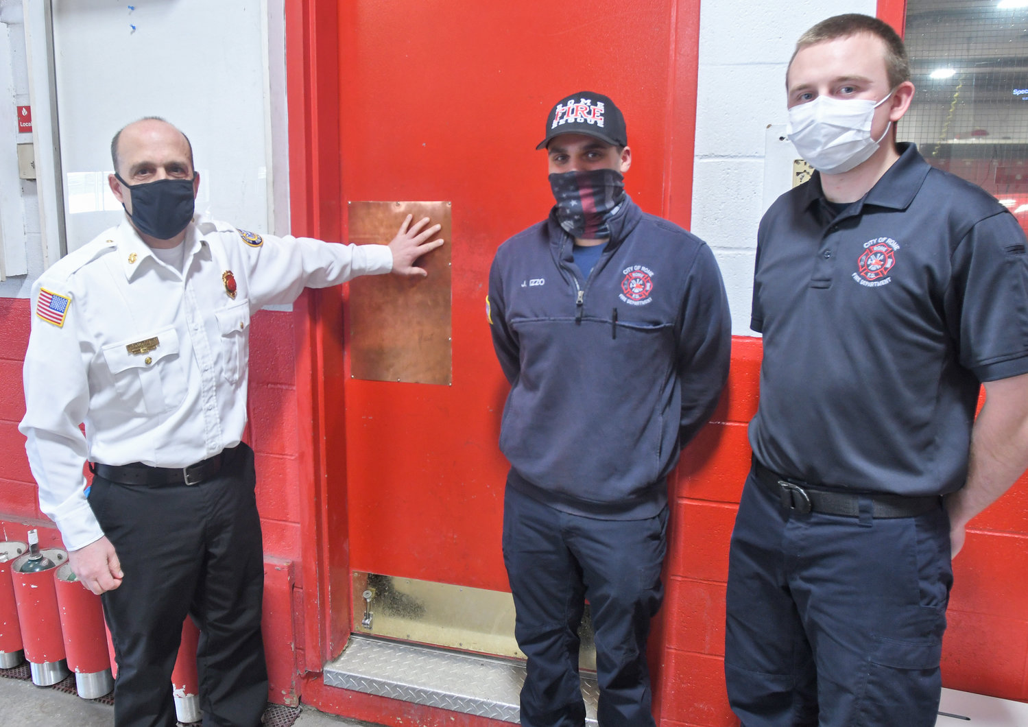 KEEPING COVID AT BAY — Rome Fire Deputy Chief David Gratch points out one of the newly installed copper pads on several doors at the Rome Fire Department in this February 2021 file photo. Revere Copper Products had donated sheets of copper, known for its antimicrobal properties, to the department to assist with its COVID-19 precautions.