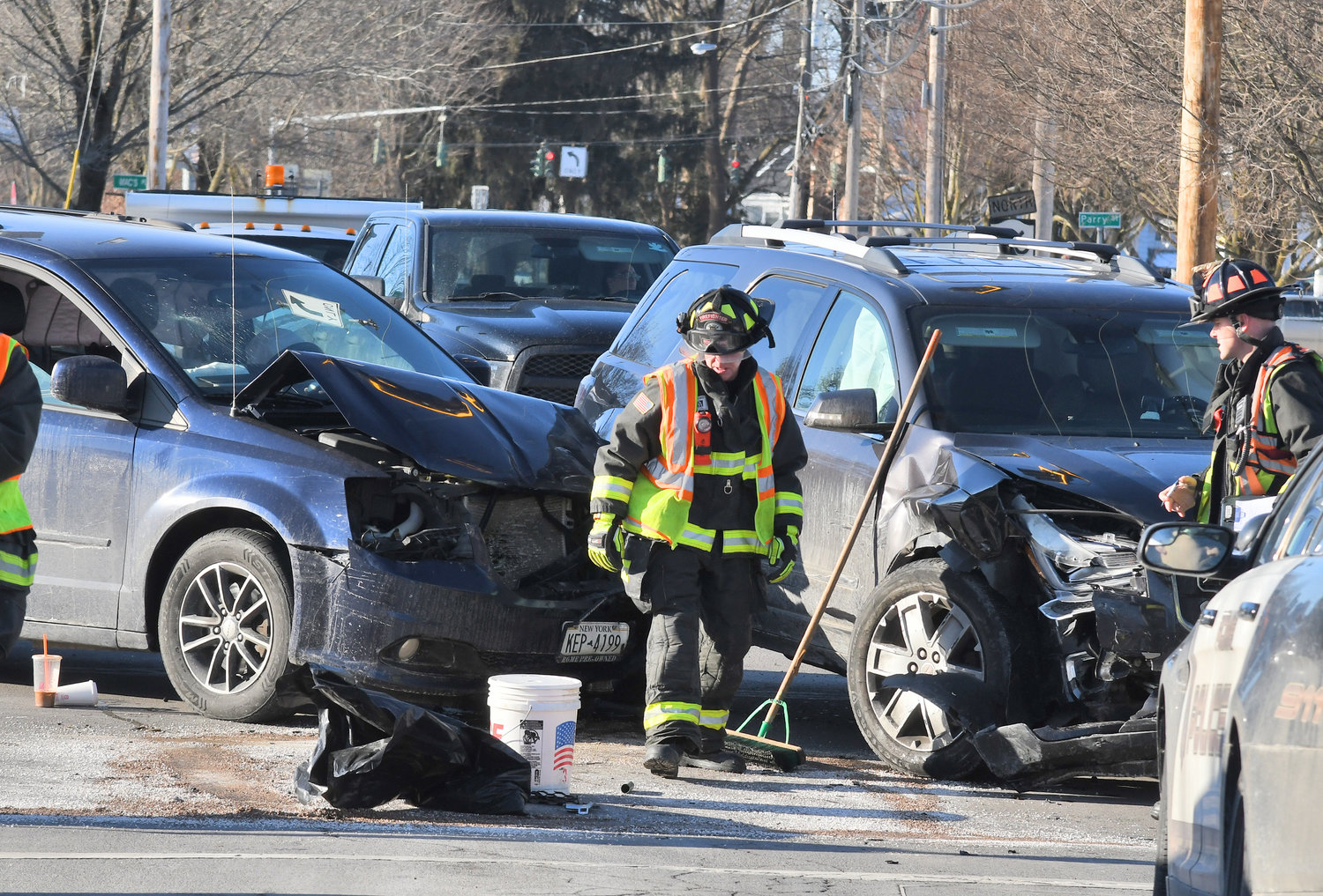 CRASH IN ROME — Rome firefighters clean up the debris after these two vehicles collided on Black River Boulevard at East Bloomfield Street Friday afternoon. Rome Police are investigating the collision and the accident report was not immediately available.