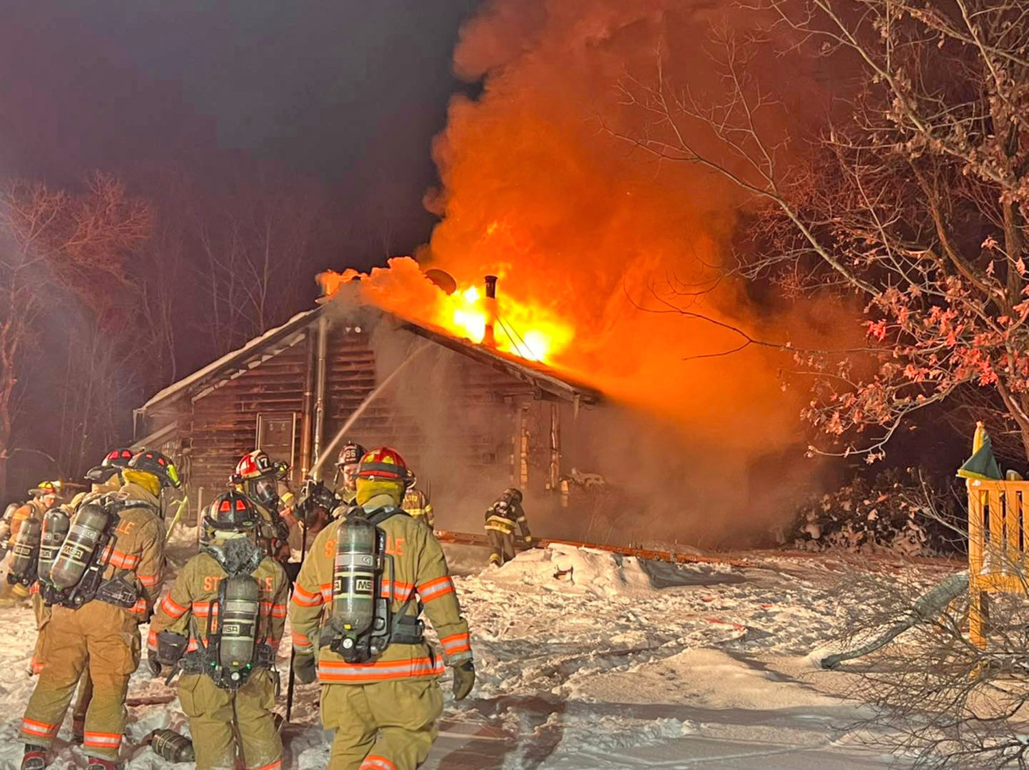 EARLY MORNING BLAZE — Stittville firefighters head towards a house fire on Soule Road in Floyd at about 3 a.m. Sunday. Crews battled frigid temperatures and very icy conditions to knock down the fire at the one-story residence.