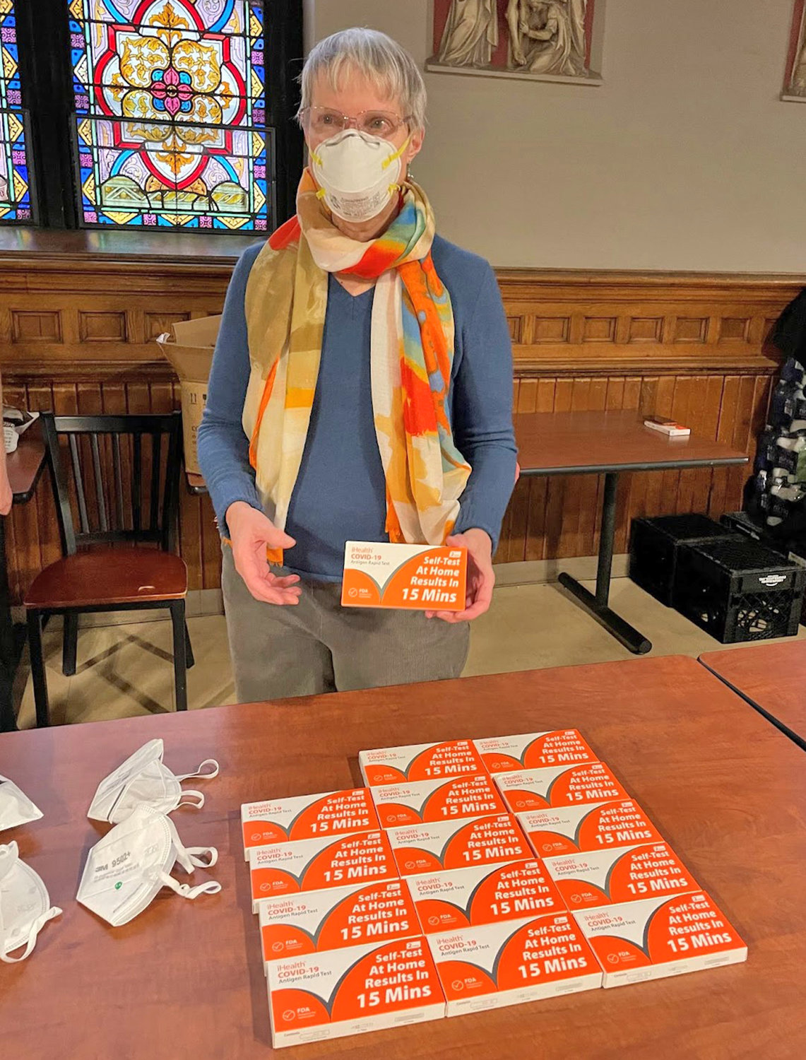 GETTING ORGANIZED — State Sen. Rachel May, D-53, Syracuse, puts together a display of at-home COVID-19 test kits which were to be given away at her annual Martin Luther King Jr. Day of Service event at the Samaritan Center in Syracuse on Monday.