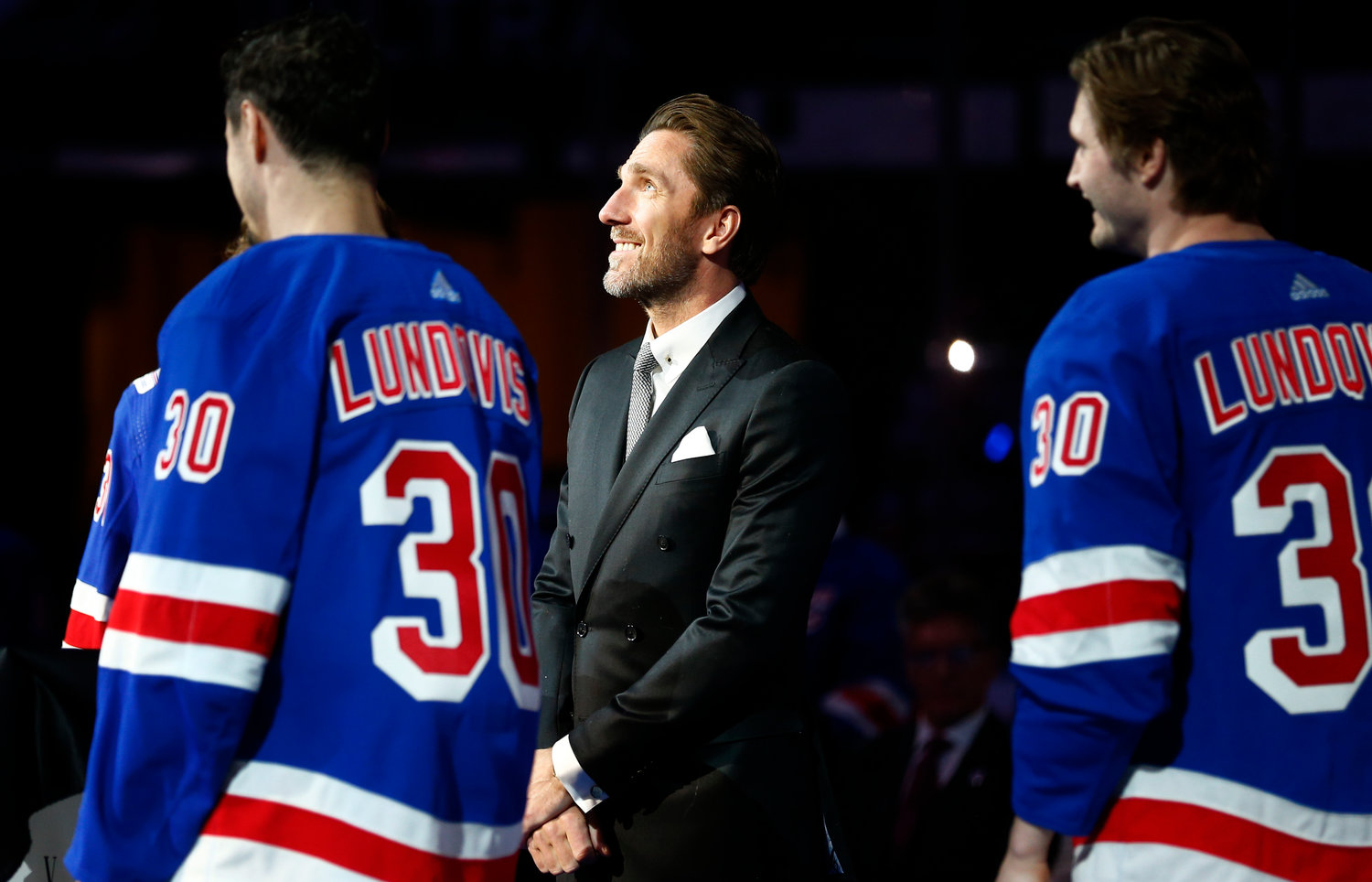 LUNDQVIST HONORED — Former Rangers goaltender Henrik Lundqvist, center, watches as his number is retired before an NHL game between the Rangers and the Wild on Friday night in New York. He was joined on the ice by current Rangers players wearing his jersey.