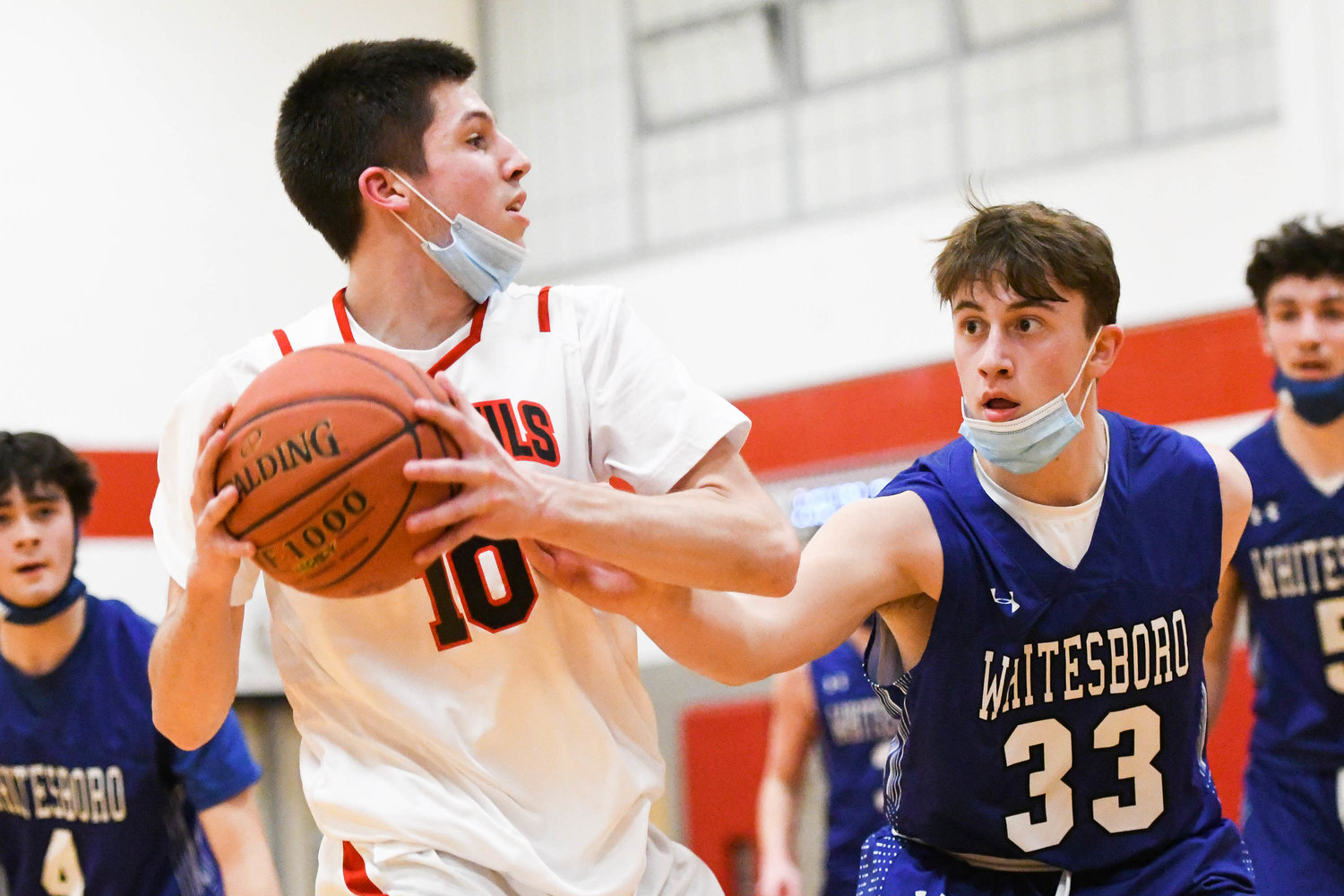 LOOKING TO PASS THE ROCK — Vernon-Verona-Sherrill’s Benjamin Wittman (10) attempts to pass the ball against Whitesboro player Daniel Russo (33) during Thursday’s Tri-Valley League game in Verona. The Red Devils won 48-47.