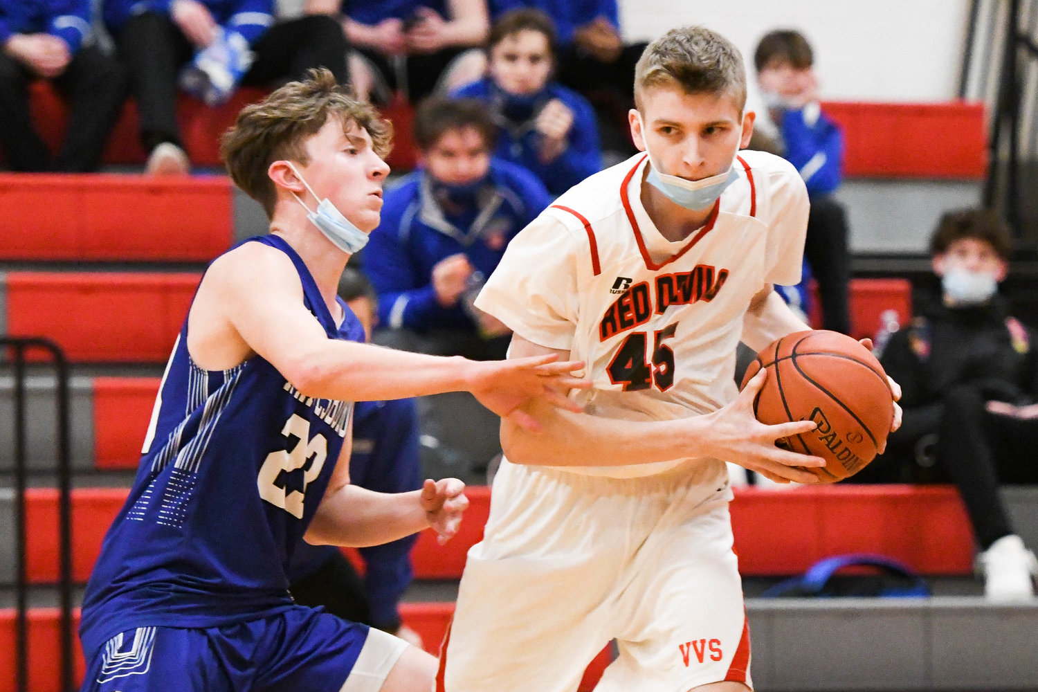 MOVING THE BALL — Vernon-Verona-Sherrill’s Nathan Costello, right, moves the ball against Whitesboro defender Caden Morris during the Tri-Valley League game on Thursday night. The Red Devils won 48-47.