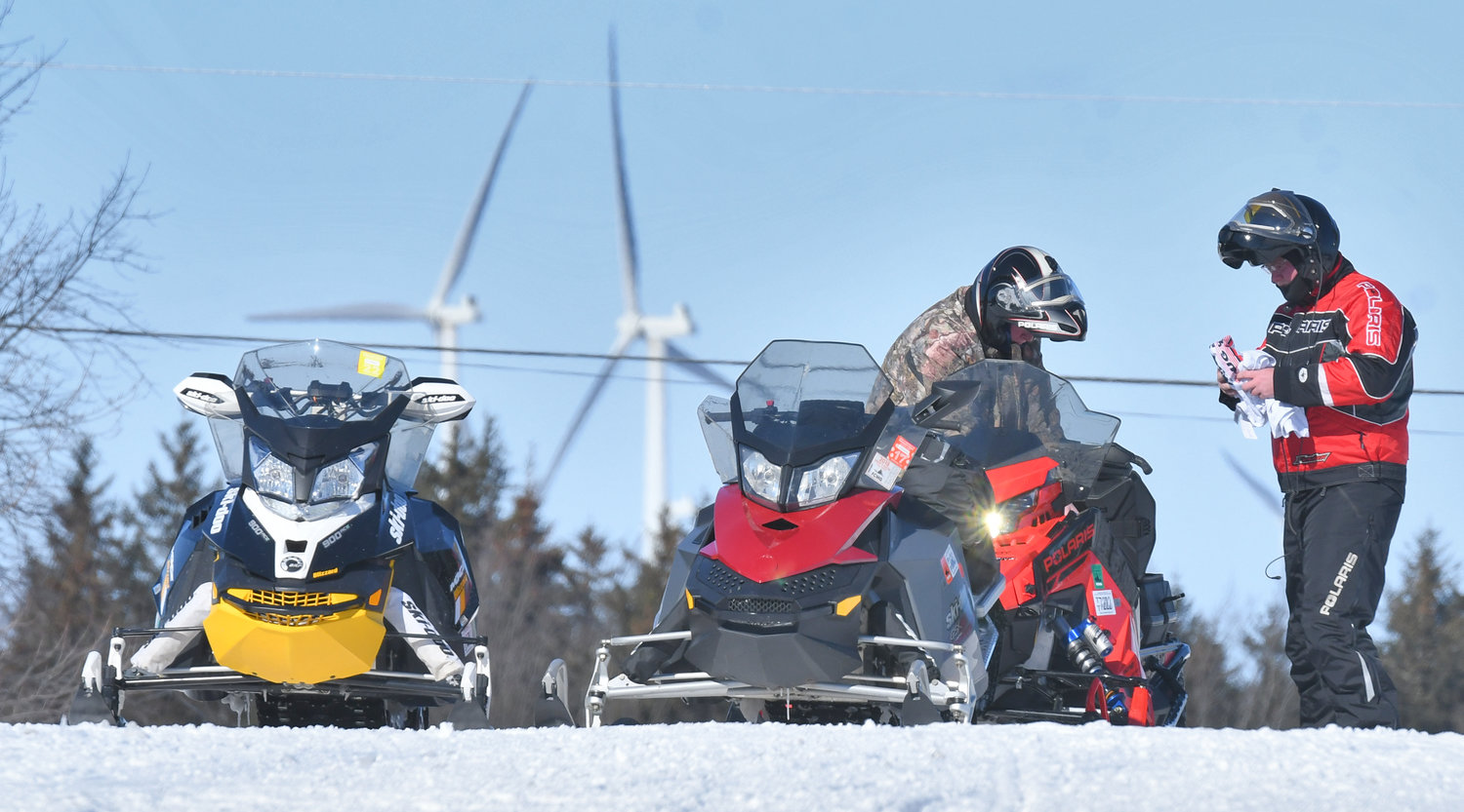 A pair of snowmobilers prepare to take off from Flatrock Inn in Lewis County Monday afternoon.