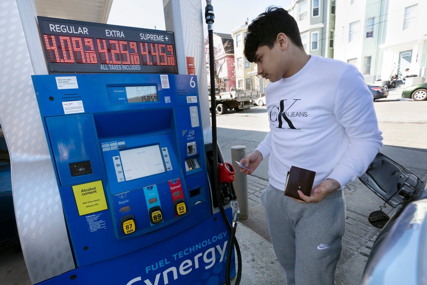 Jason Ventura prepares to pump gas into his vehicle, Friday, March 4, 2022, in Boston.