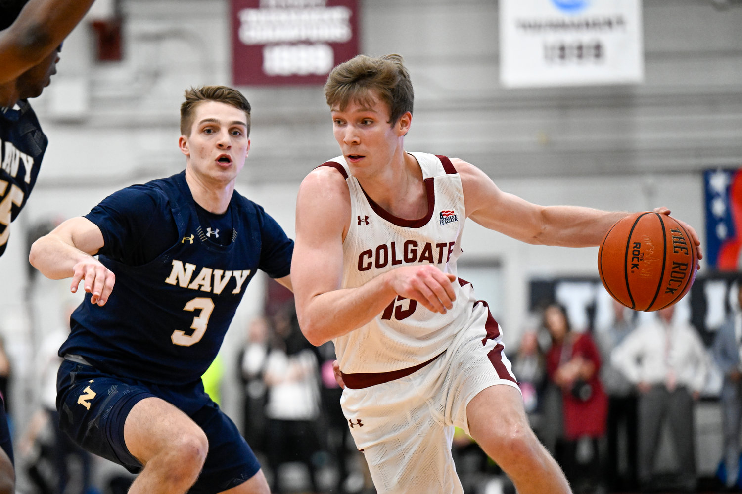 NCAA TOURNEY BOUND — Navy guard Sean Yoder (3) defends against Colgate guard Tucker Richardson (15) during the first half of the Patriot League men’s tournament championship on Wednesday night in Hamilton. The Raiders won, 74-58.