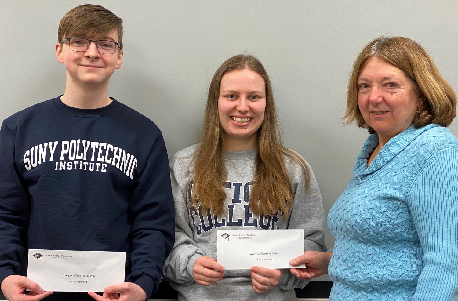 SCHOLARS — College students Kyle Clark, left, and Molly Closinski, center, receive $1,000 scholarships from Rome College Foundation President Suzanne Carvelli, during a presentation ceremony last week.