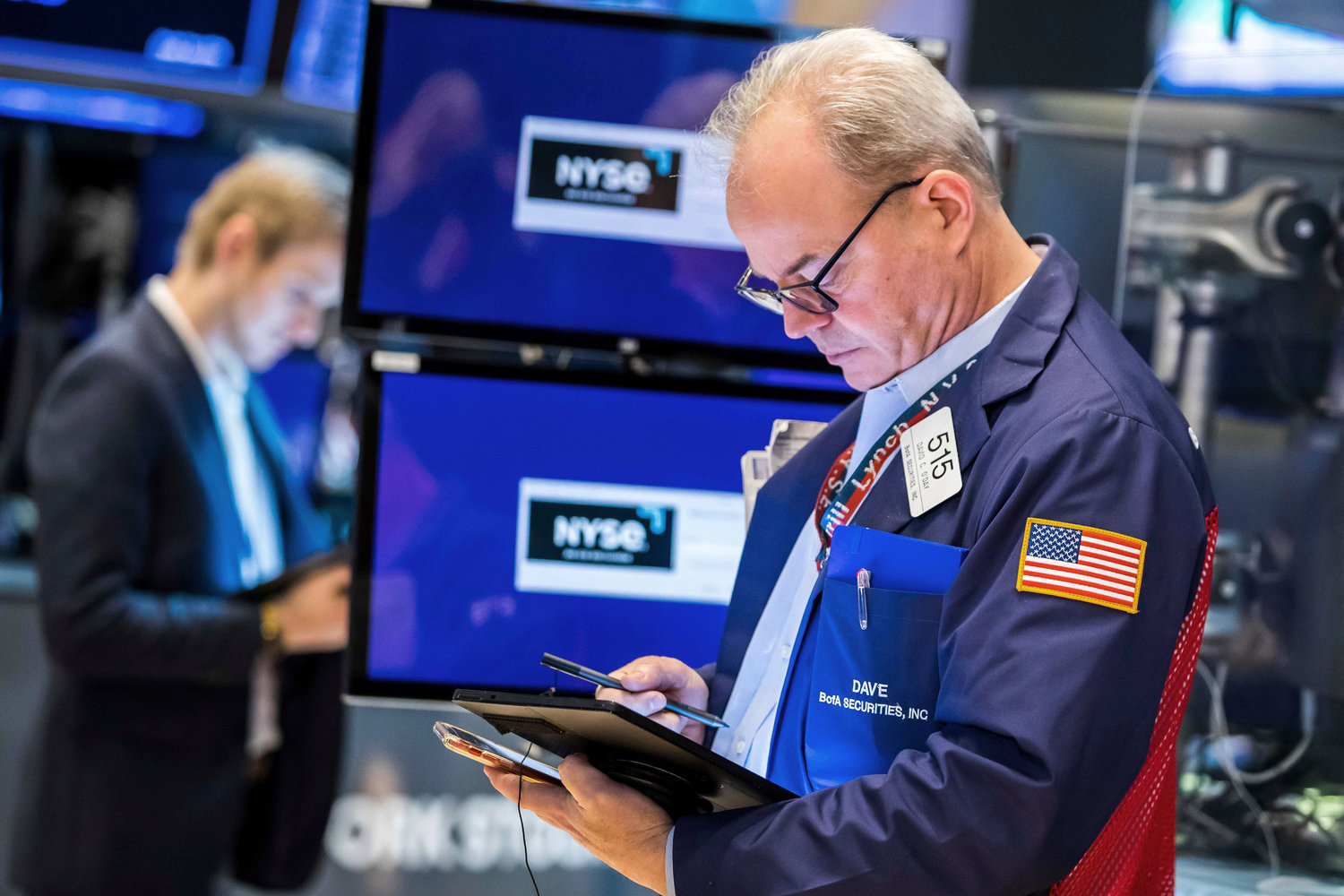In this photo provided by the New York Stock Exchange, trader David O'Day, right, works on the floor, Thursday, March 31, 2022. Stocks edged lower in midday trading on Wall Street Thursday and oil prices fell as President Joe Biden ordered the release of up to 1 million barrels of oil per day from the nation's strategic petroleum reserve. (Courtney Crow/New York Stock Exchange via AP)