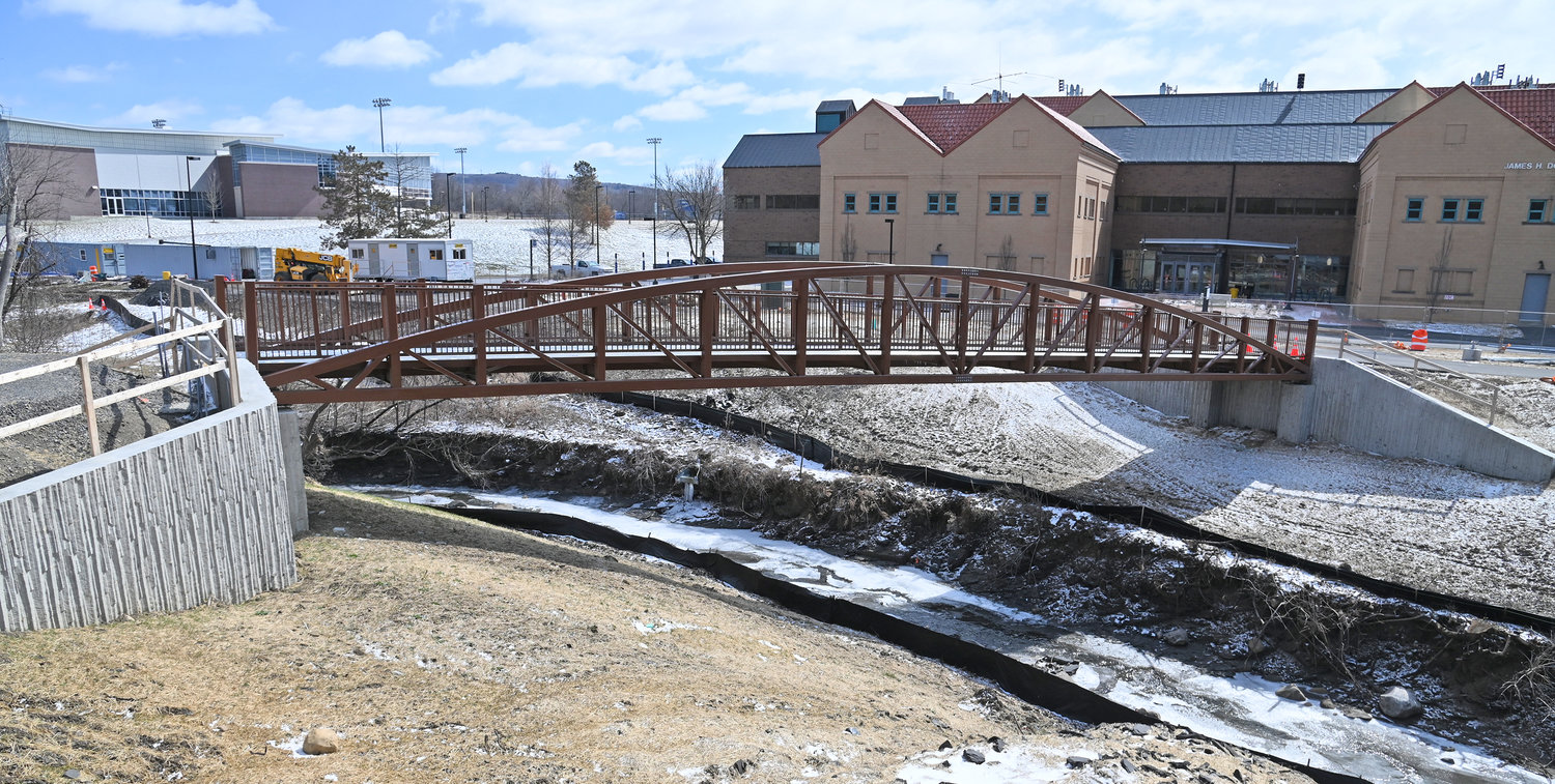 the newly place pedestrian bridge in the background. The bridge is between the Campus Center and Donovan Hall.