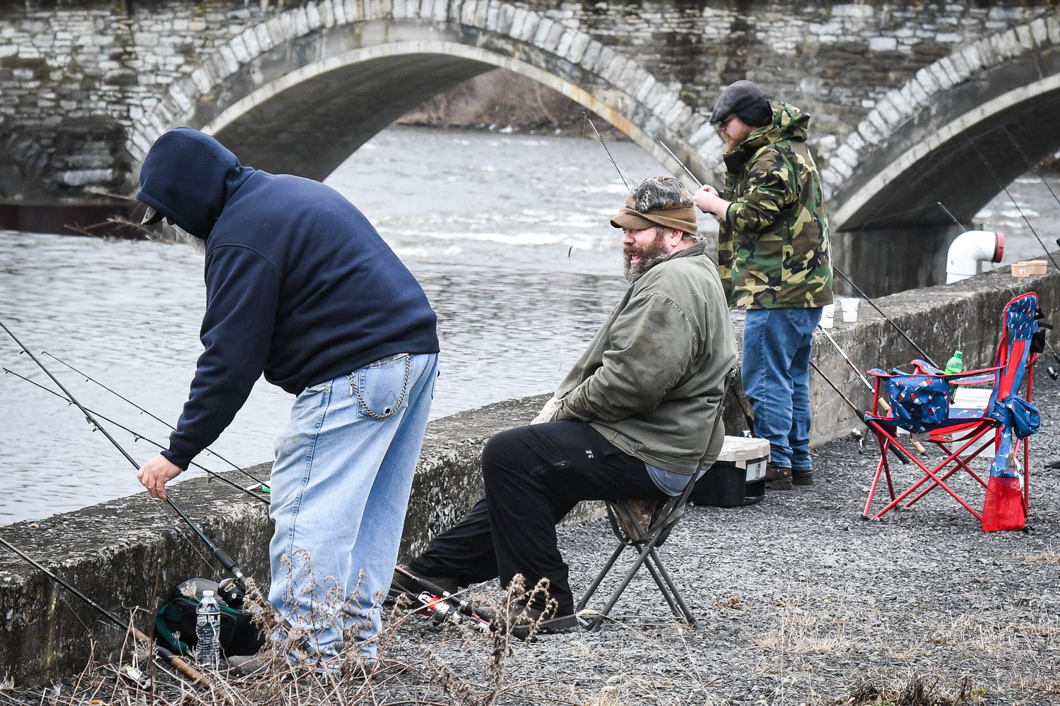 Anglers go fishing near the Newport Stone Arch Bridge during opening day for trout season on Friday morning.