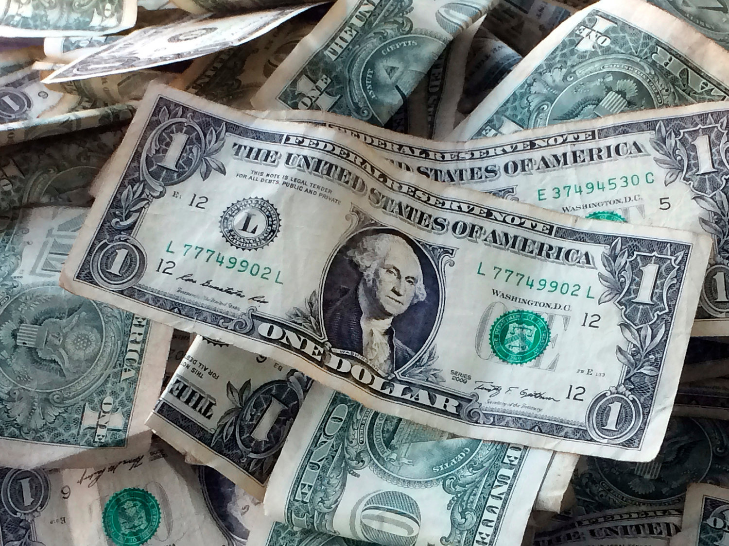 AUTOMATIC — Dollar bills are shown in this file photo. Automating bill payments and savings deposits can save time, but it can also cause problems.