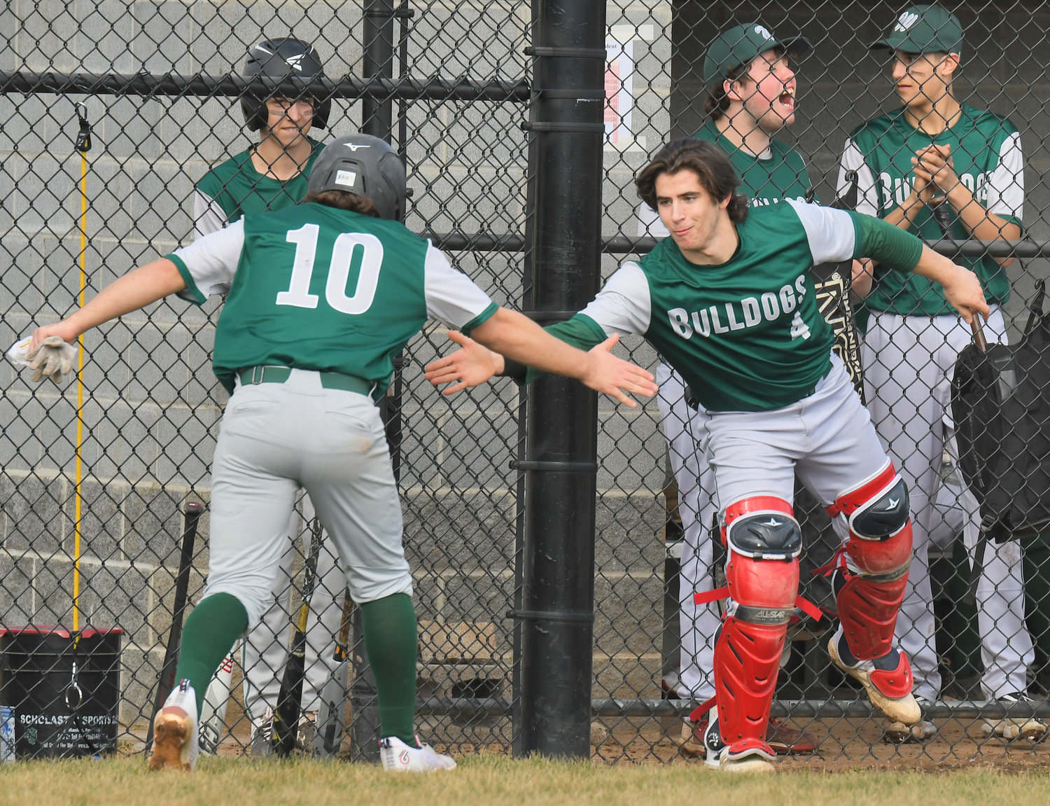STRIKING FIRST — Westmoreland’s Mike Scalise, left, celebrates with catcher Caleb Miller after he scored a run in the first inning of the team’s 11-2 win at home Tuesday against Oriskany.