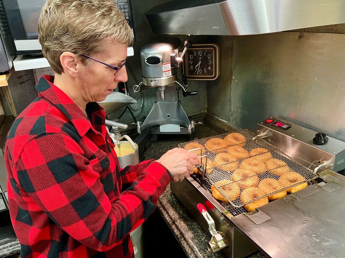 READY TO FLIP — Tina Merrihew fries donuts fresh every morning at the Washboard Donut Shoppe in Tupper Lake.