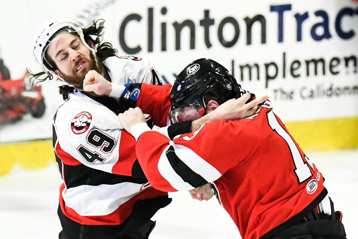 DOING DAMAGE -- Utica Comets forward Patrick McGrath, right, punches Scott Sabourin of the Belleville Senators in the jaw during the game on Wednesday night. The first period fight just over three minutes into the game set the tone for a physical affair between the North Division teams. Utica lost 4-3 in overtime at home but remains at the top of the division standings with only nine games left in the regular season. The two teams will meet again Friday, this time in Canada.
