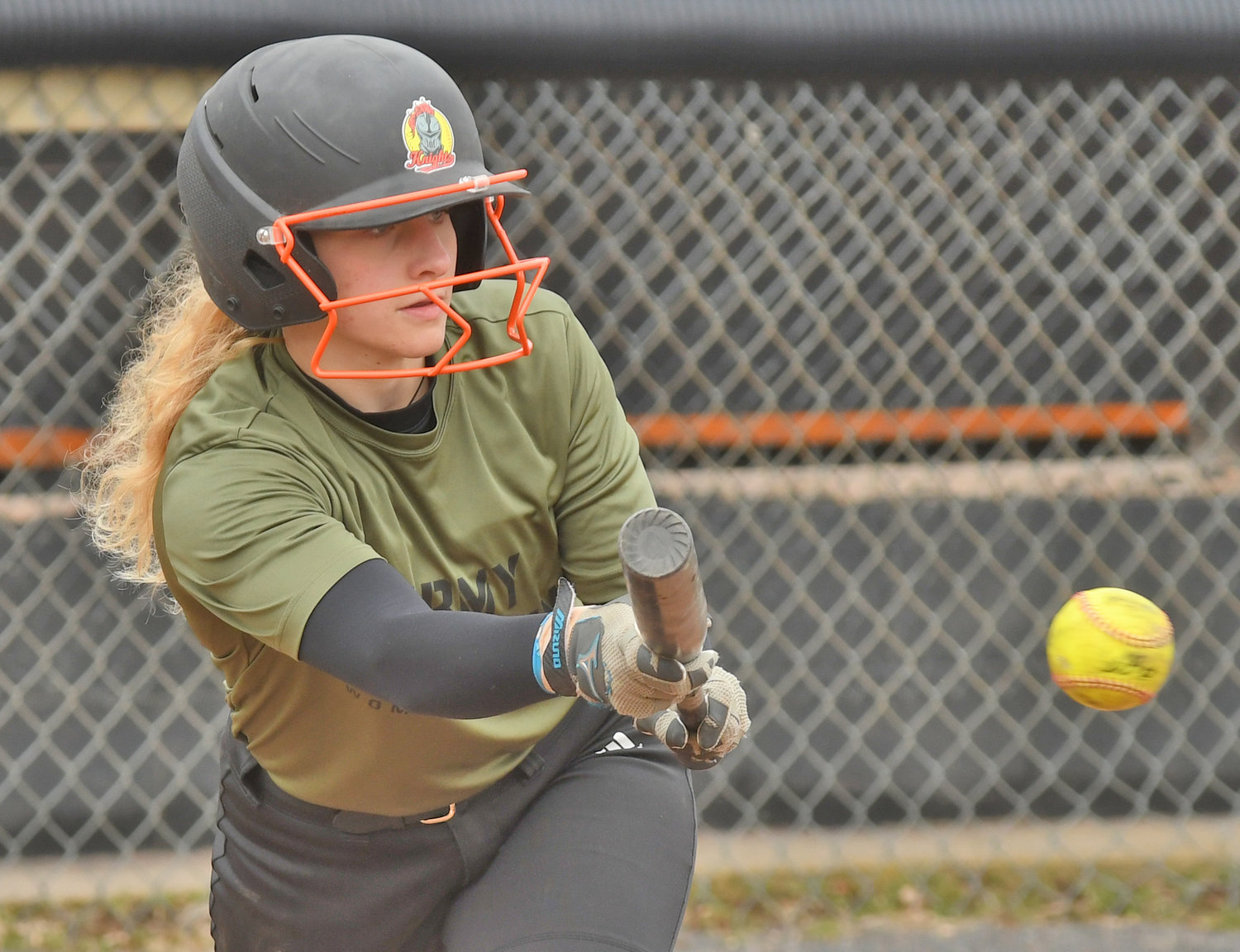 LAYING THE BUNT DOWN — Lauren Dorfman bunts during practice at Kost Field. The senior missed all of last season with an injury sustained in soccer but is back and should start at catcher and be a top-of-the-lineup threat on offense.