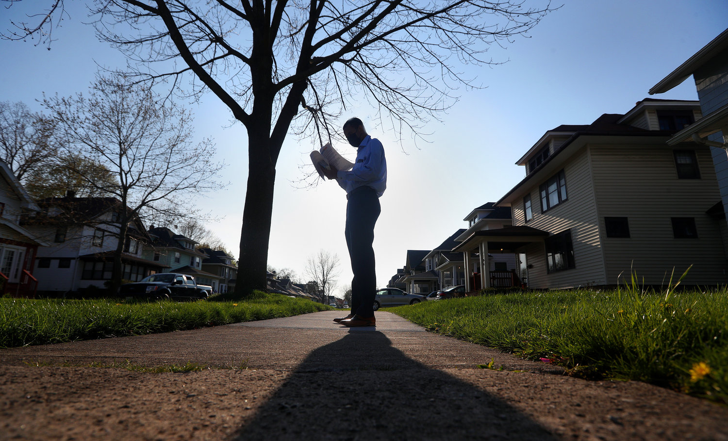 ON THE (SHADED) CAMPAIGN TRAIL — Rochester Mayor Malik Evans campaigns in the 19th Ward in Rochester in this AP file photo. Evans campaigned last year on a promise to “promote  environmental justice in every neighborhood ... (while) making Rochester an environmentally friendly city of the future.”