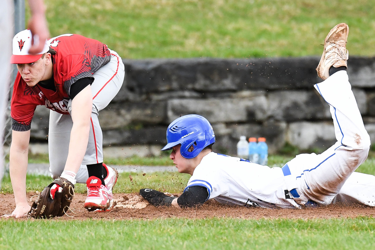 SAFE AT THIRD — Whitesboro player Colin Skermont slides safely into third base as Vernon-Verona-Sherrill’s Connor Tiffin has trouble with a wild throw during a non-league baseball game on Wednesday in Whitesboro. The Warriors won 9-2.